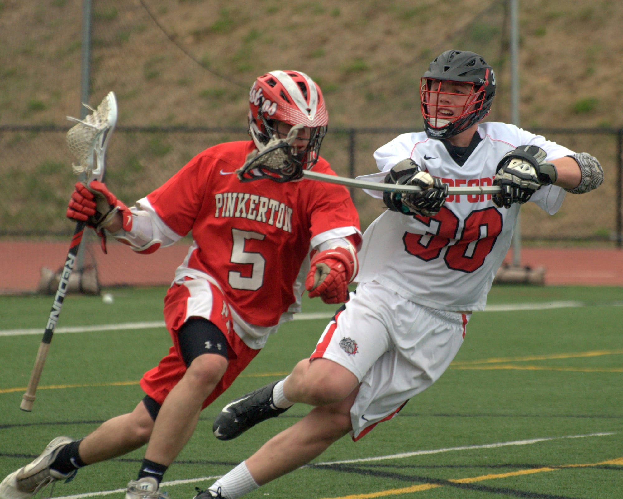 Bedford's Gardner Gendron defends against Pinkerton's Evan Sweeney.