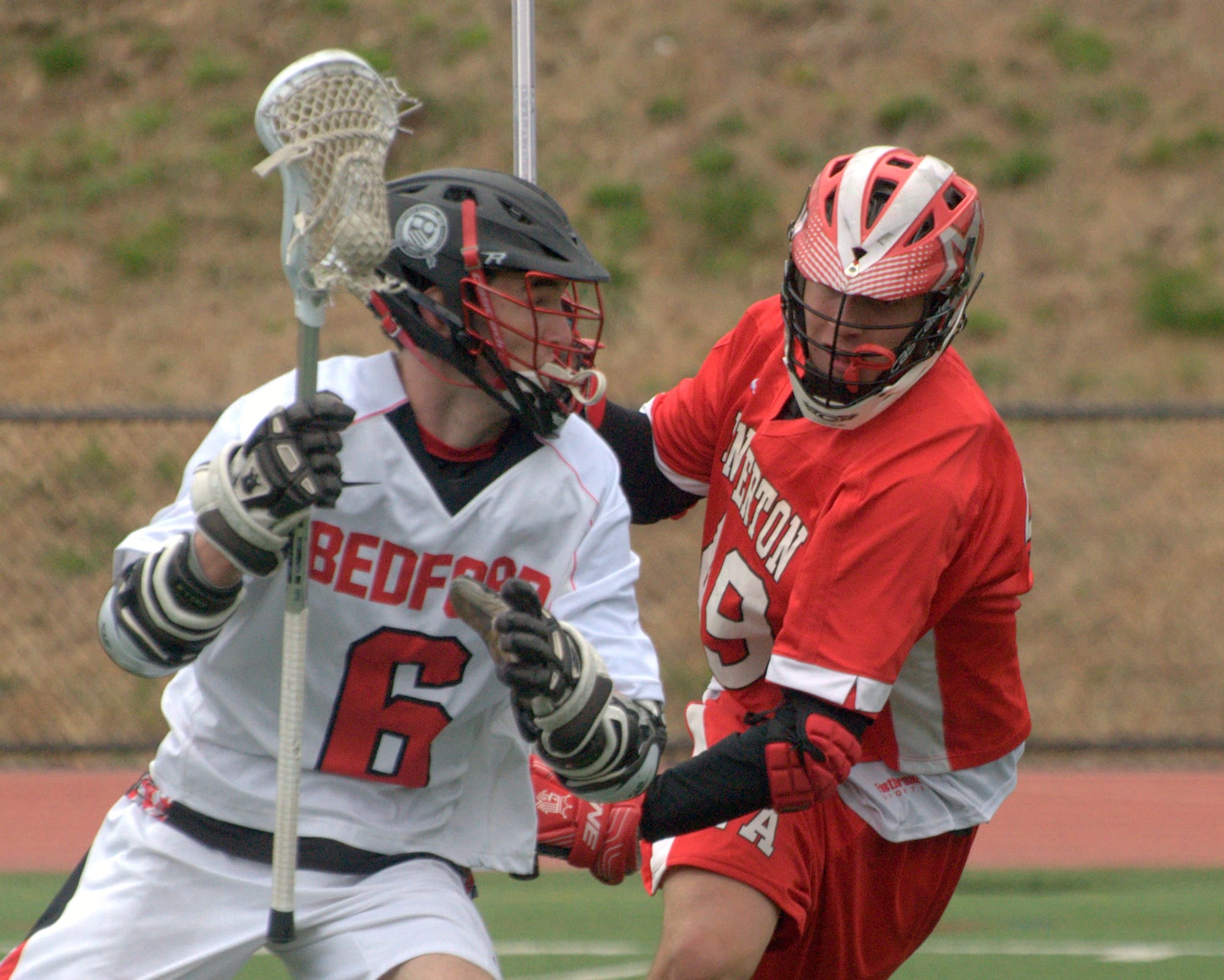 Pinkerton's Connor Delea tries to slow down Bedford's Dan Colella during Wednesday's game.