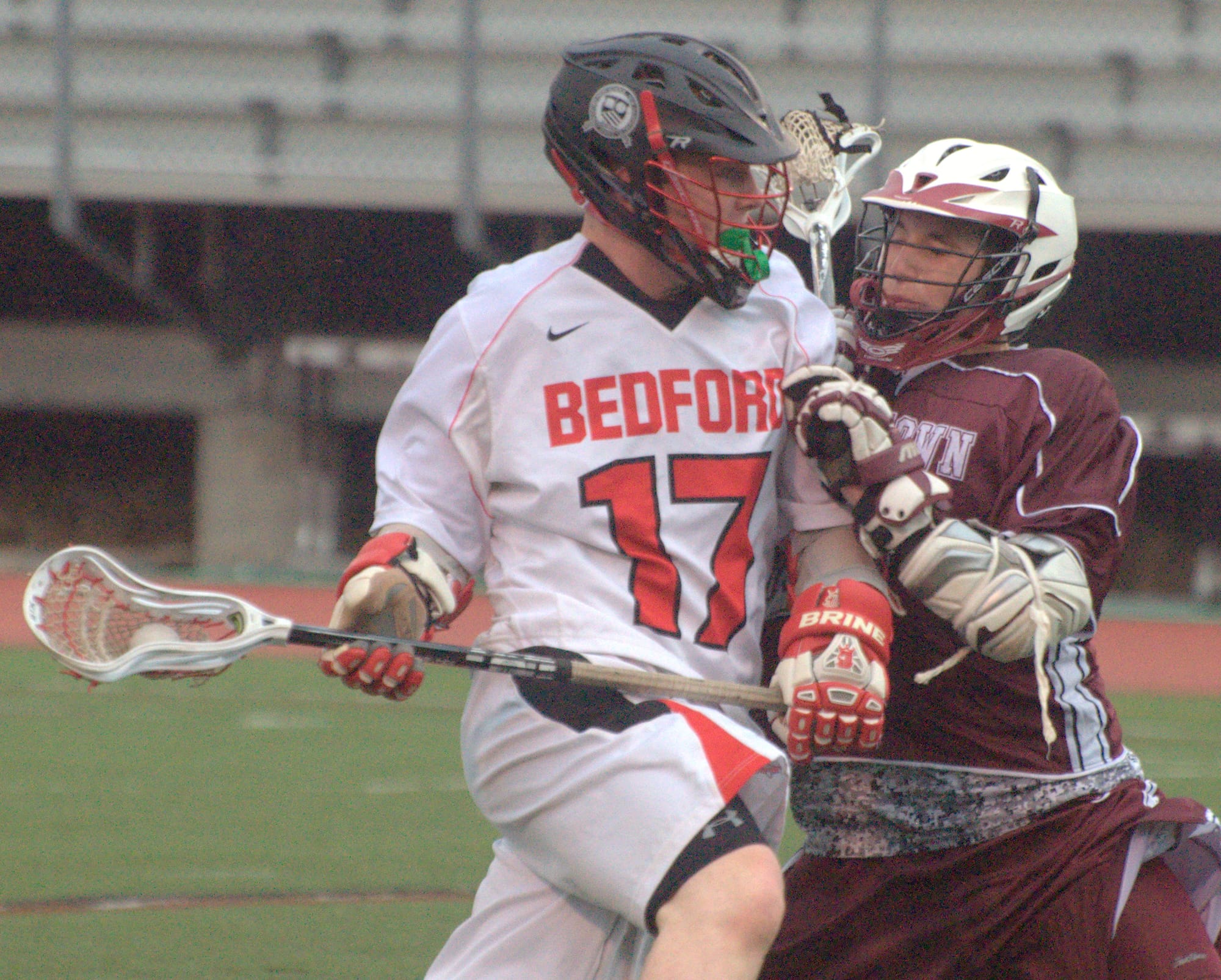 Bedford's Kyle Colella tries to fight his way past a Goffstown player during Wednesday's game.