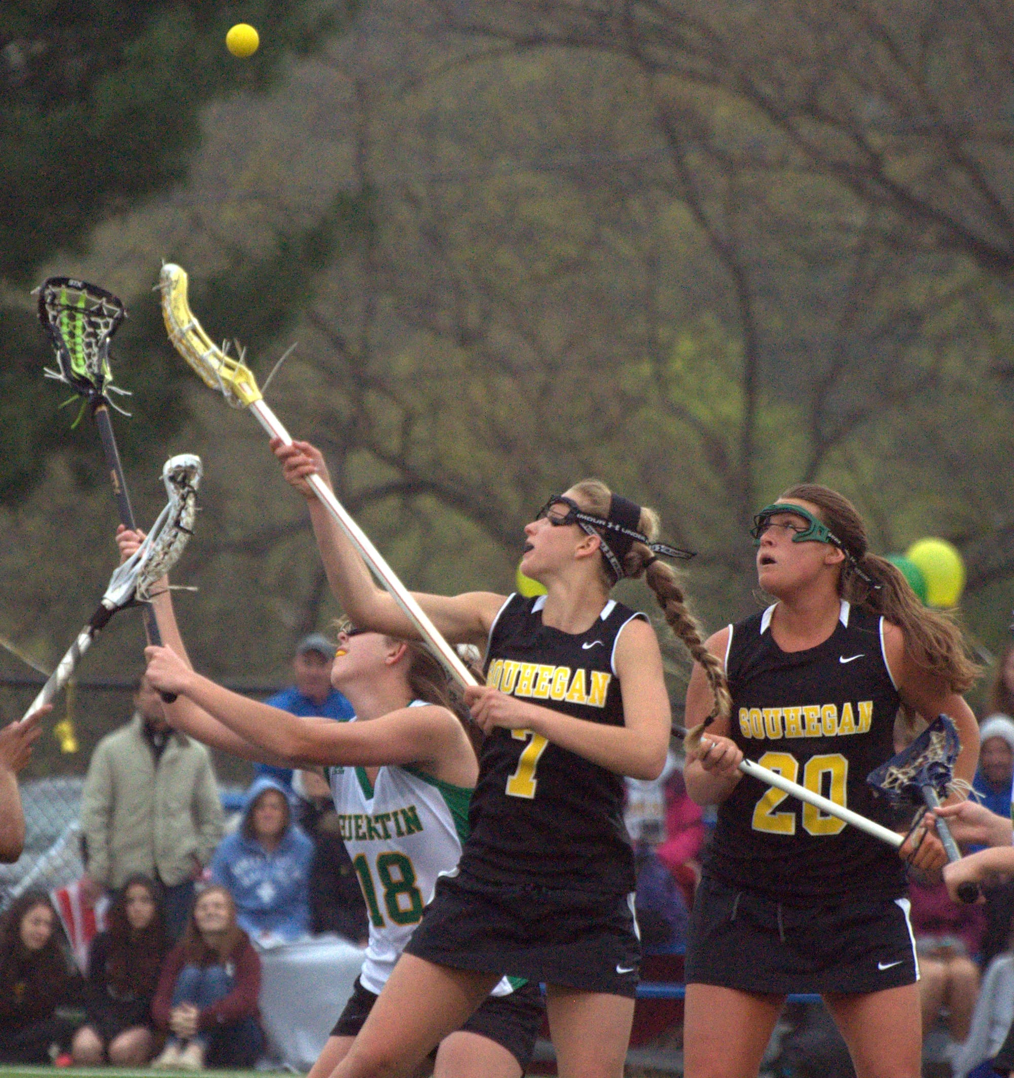 Souhegan's Jesse Jay and Bishop Guertin's Bryn Carroll try to control the ball off a draw during Friday's game.