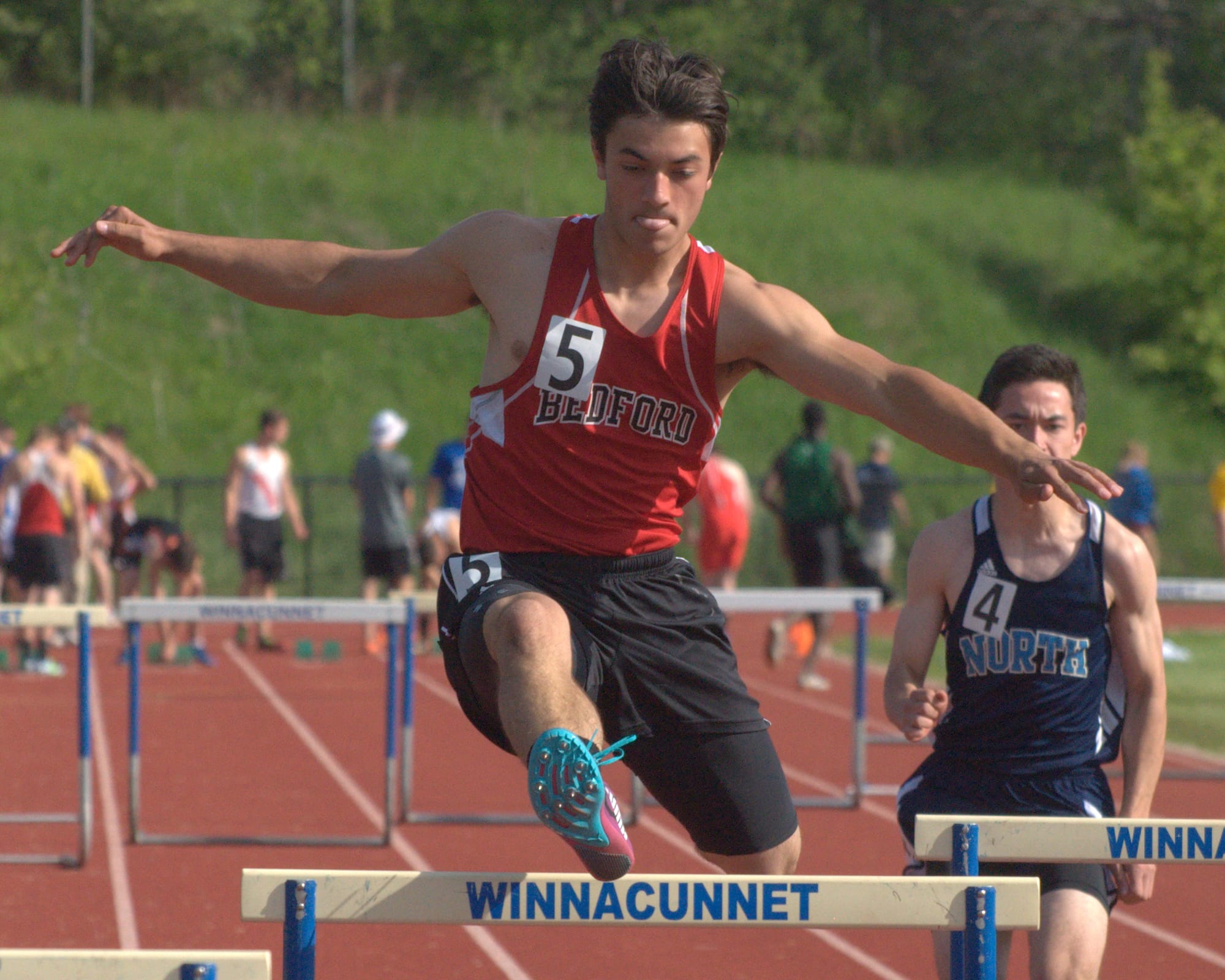 Bedford's David Norfleet runs in the 300 hurdles.