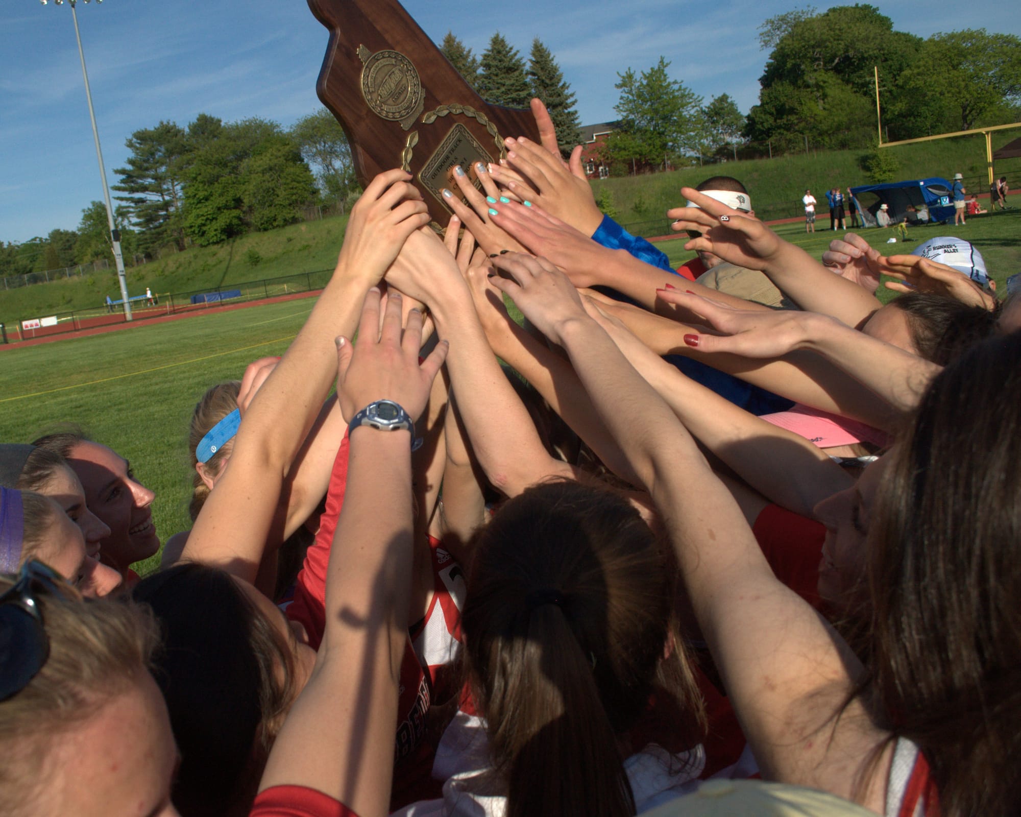 The Bedford girls track team celebrates after winning the Division I title. For more photos, go to the Photo Album.
