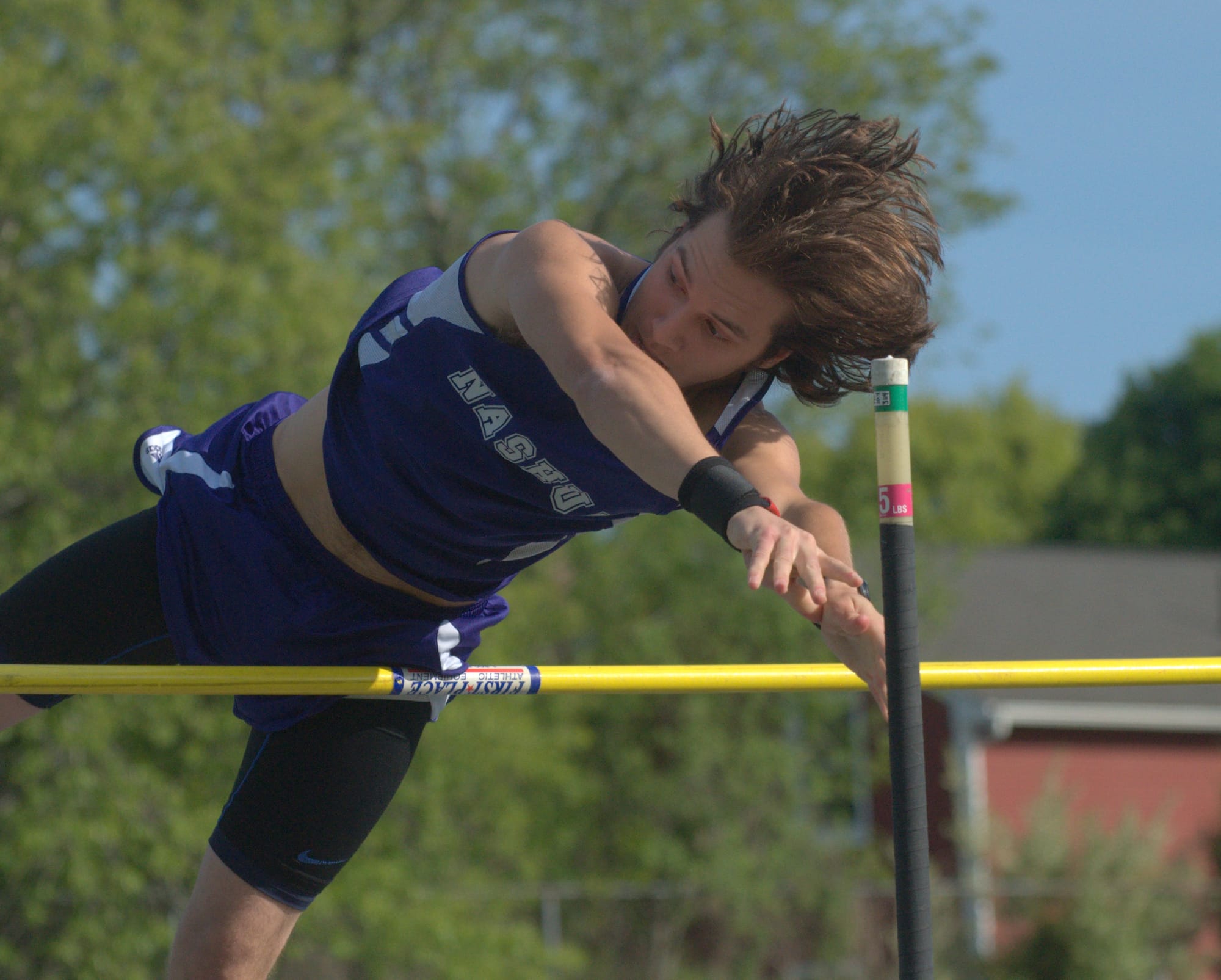 Nashua South's Tyler Plourde competes in the pole vault.