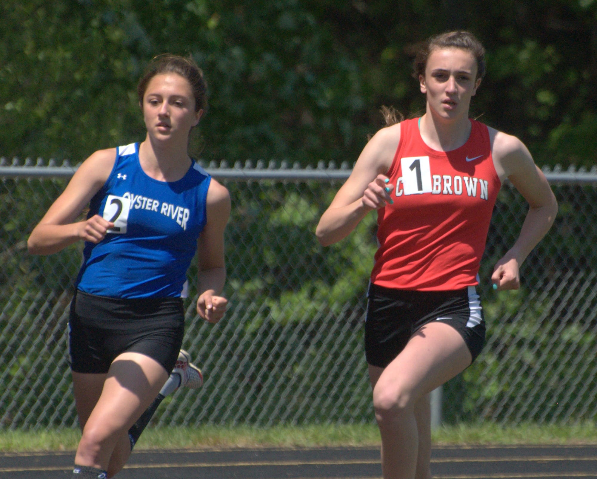 Coe-Brown's Hannah Parker and Oyster River's Maegan Doody run during the girls 800-meter run at Saturday's Division II meet.