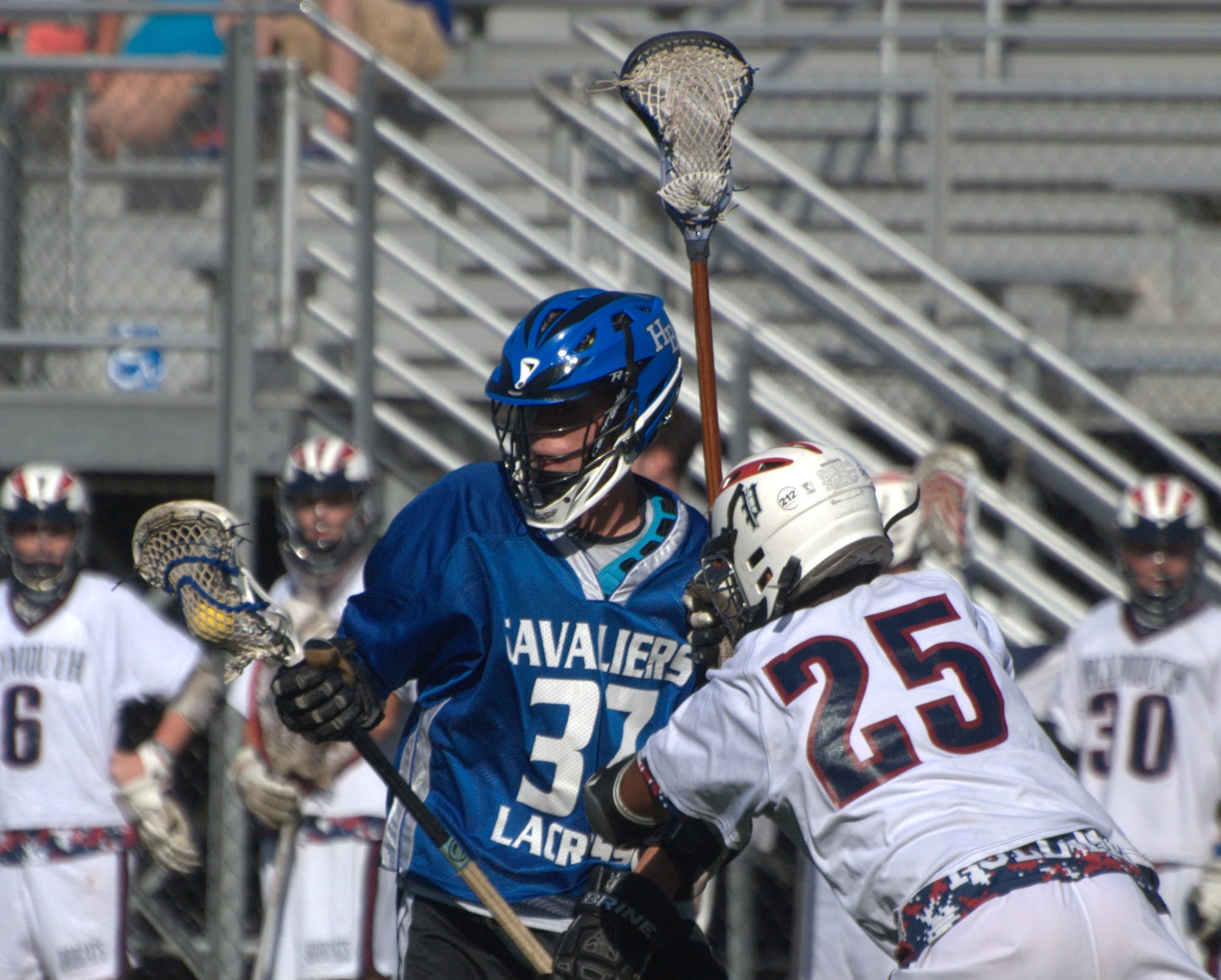 Hollis Brookline's Patrick Dunn tries to avoid a hit from Plymouth's Amani Mwingira.