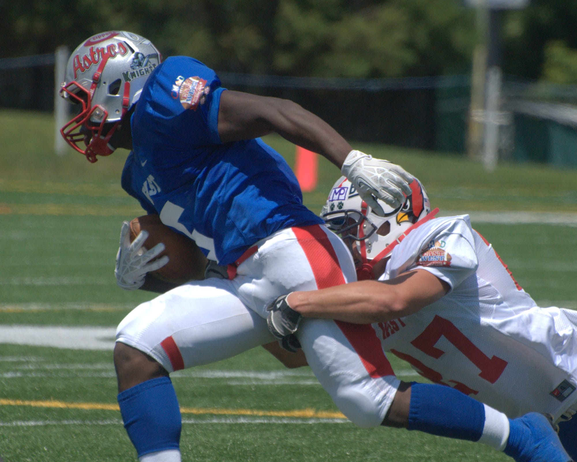 West's John Thomas tries to bring down East's Manny Latimore.