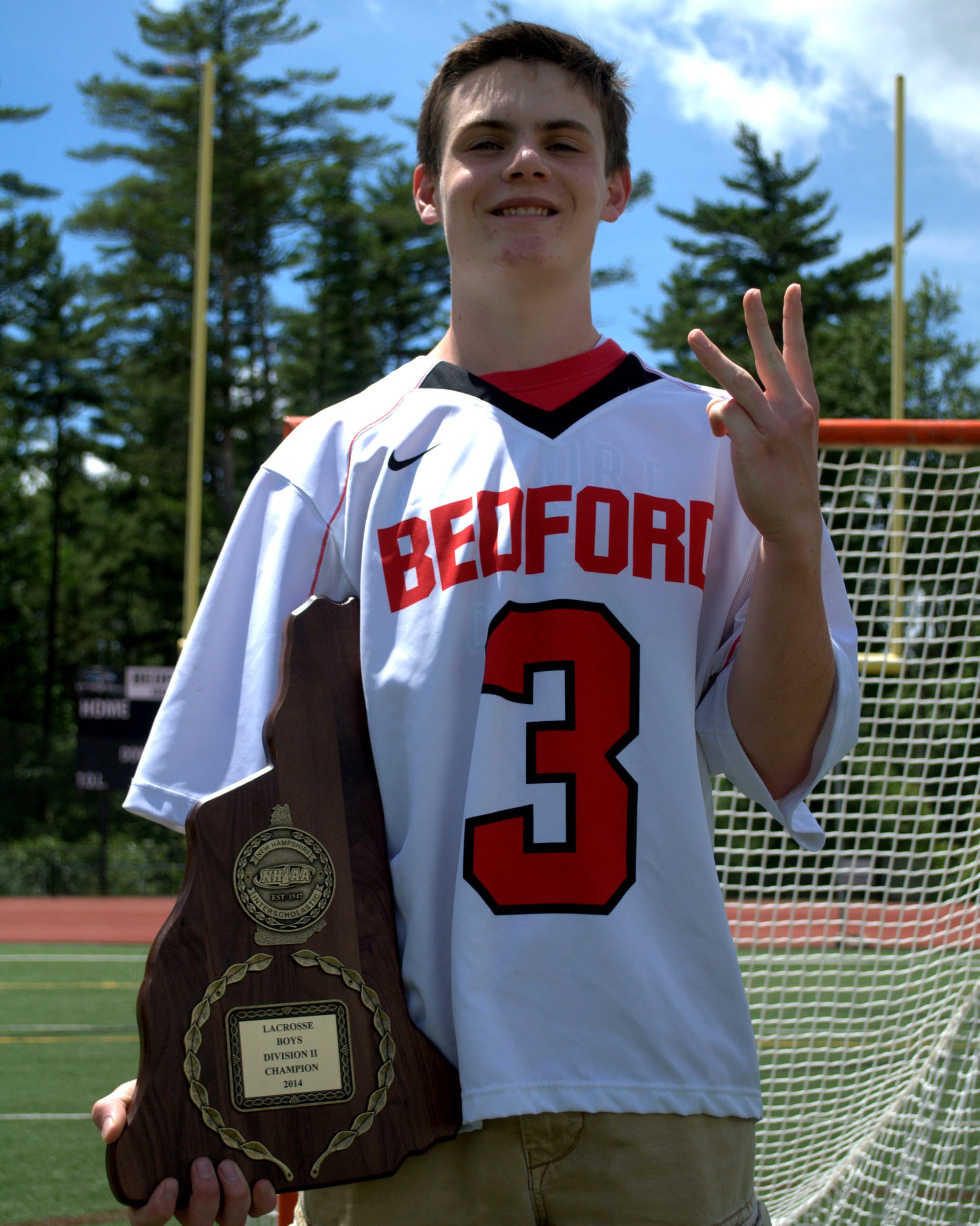 Dakota Clark and the 2014 Division II championship plaque.