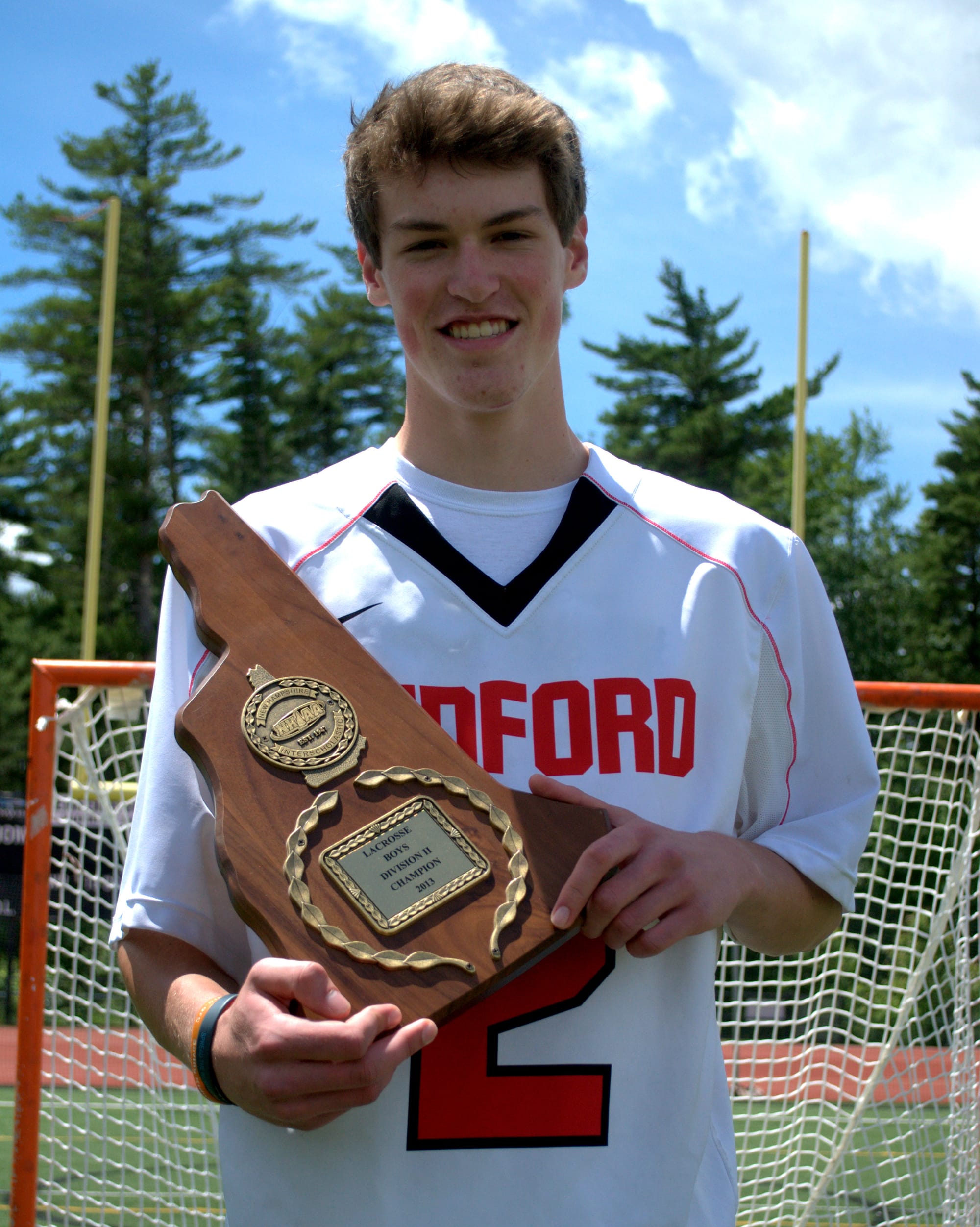 Sam Stanton and the 2013 Division II championship plaque.