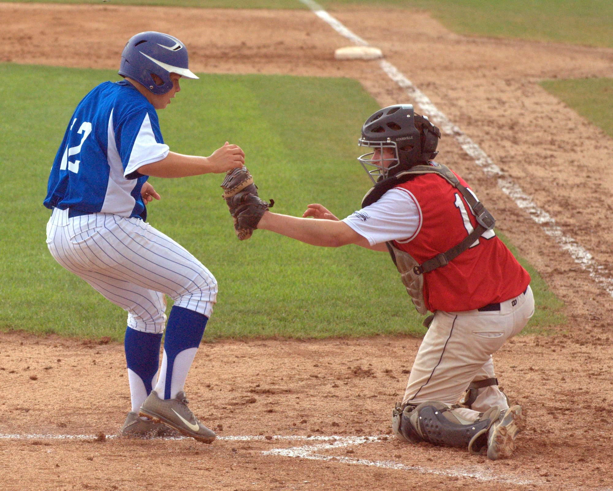 Lebanon's Tanner Simms reaches out to tag Derry's Austin Hall.