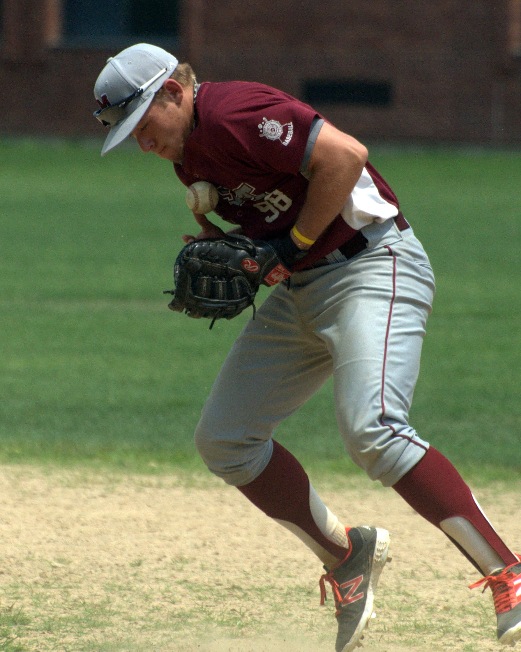 Merrimack's Brendan Holt tries to get a hold of a groundball.