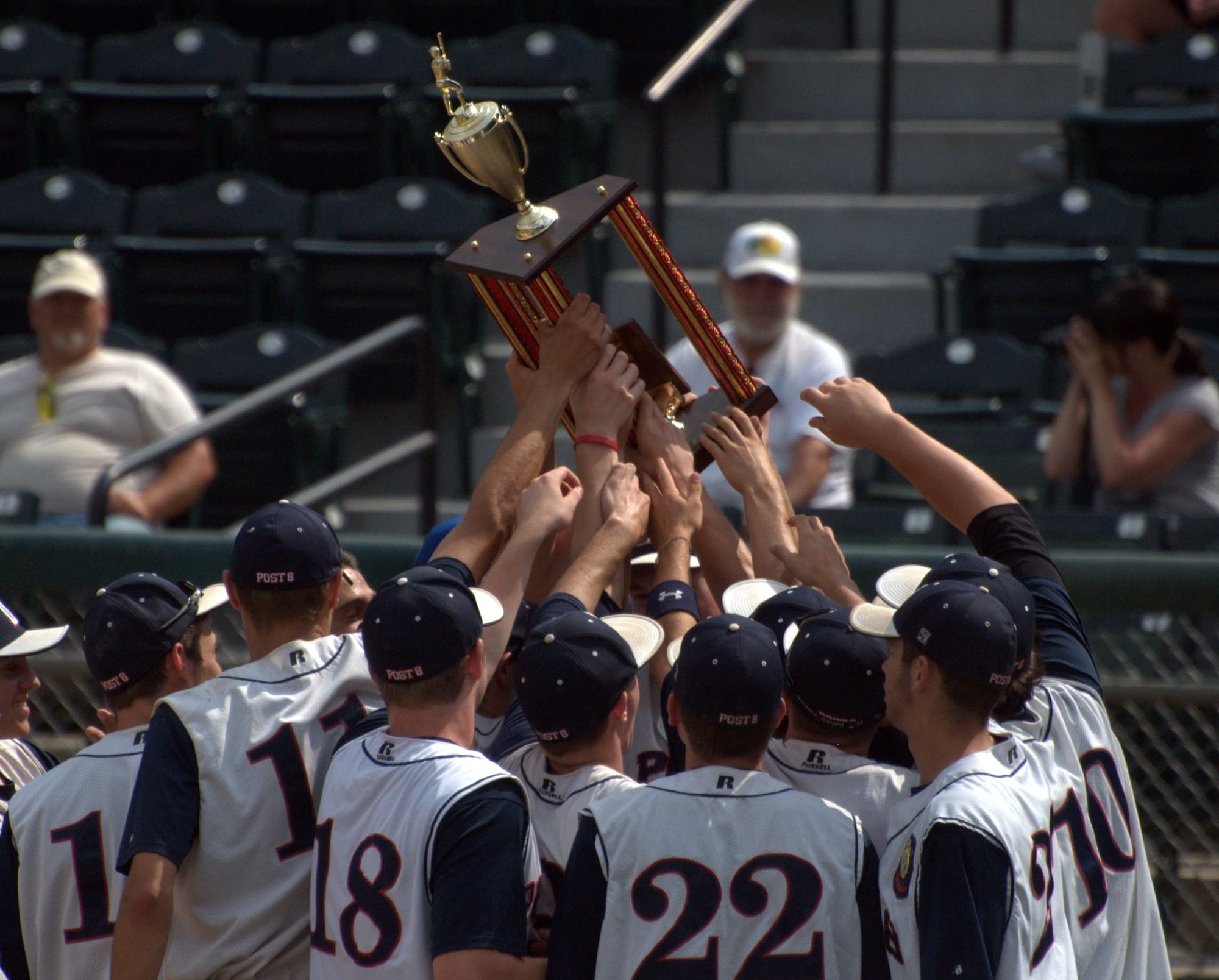Dover players hold up the American Legion Senior Championship trophy after beating Derry on Tuesday.
