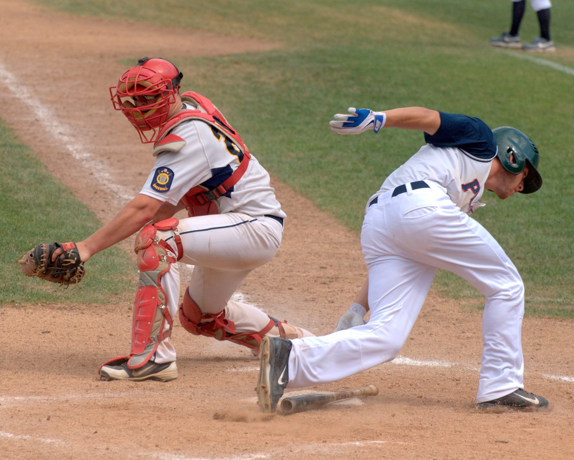 Dover's Mike Wasserman scores a run before Hudson's Greg Emanuelson can make a tag during Saturday's game.