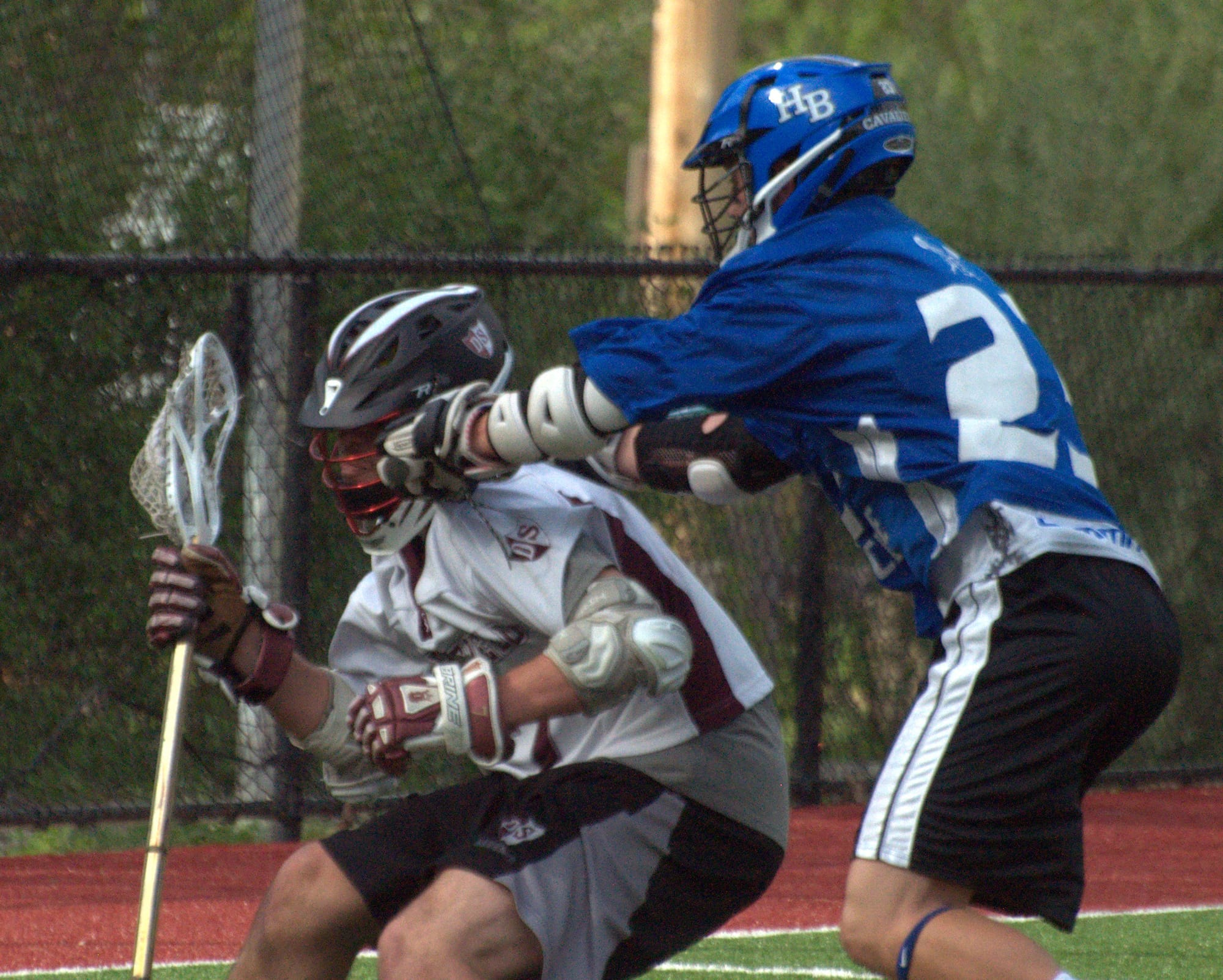 Hollis Brookline's Joe Brooks tries to slow down a Derryfield player during the regular season.