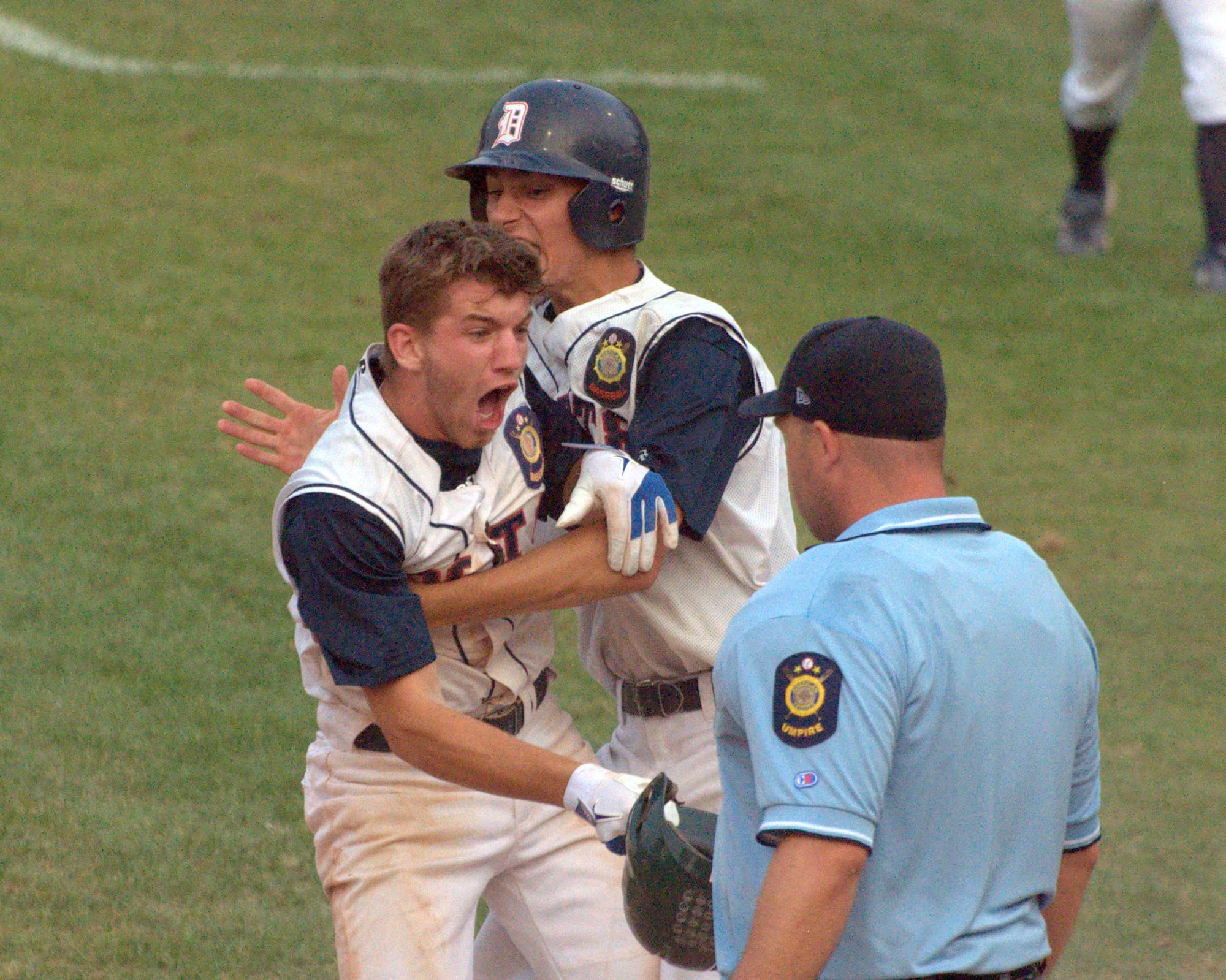 Dover's Mike Wasserman, left, celebrates after scoring the winning run in the 12th inning against Lebanon.