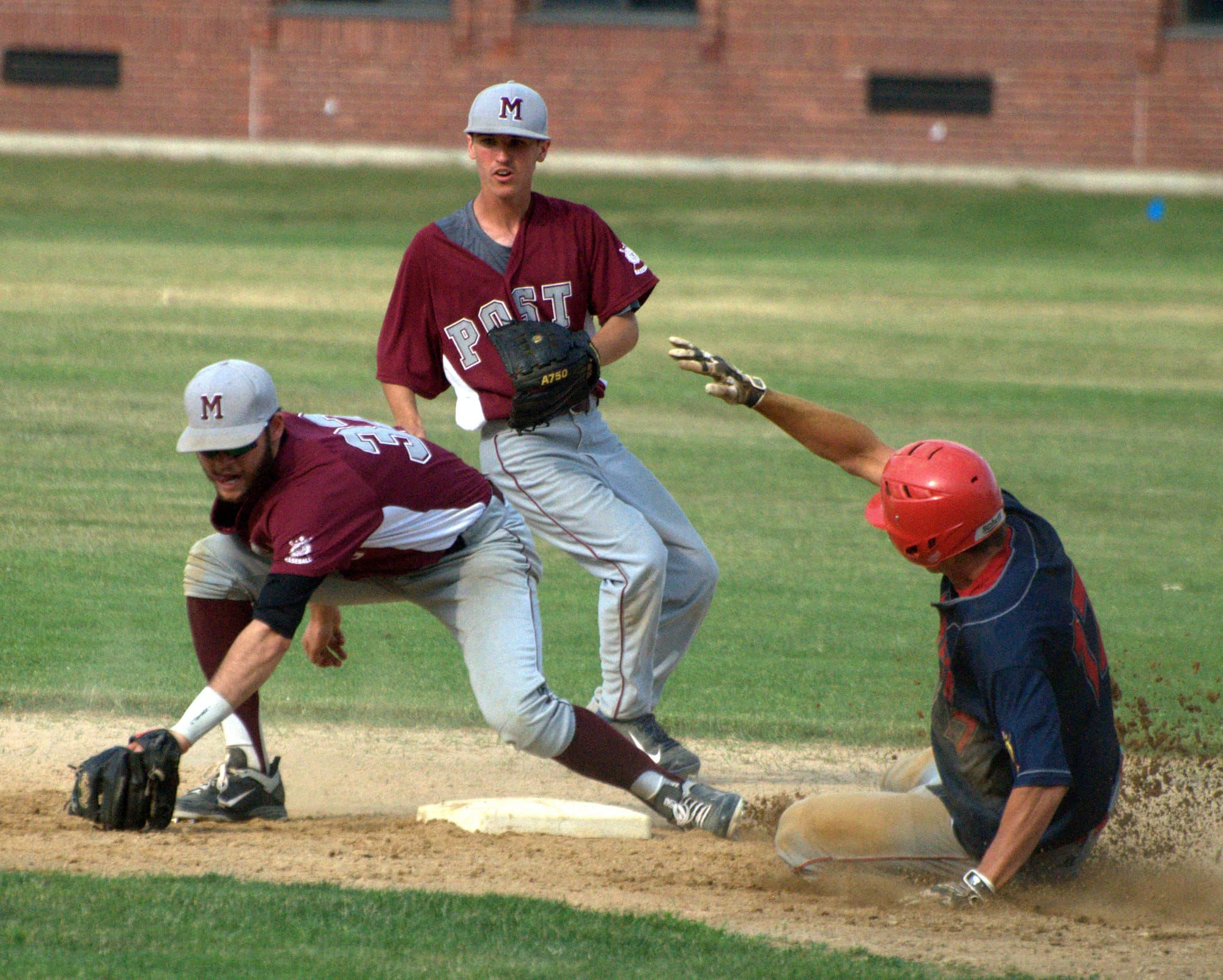 Rochester's Justin Jewell slides into second before Merrimack's Taylor Black can make the tag.