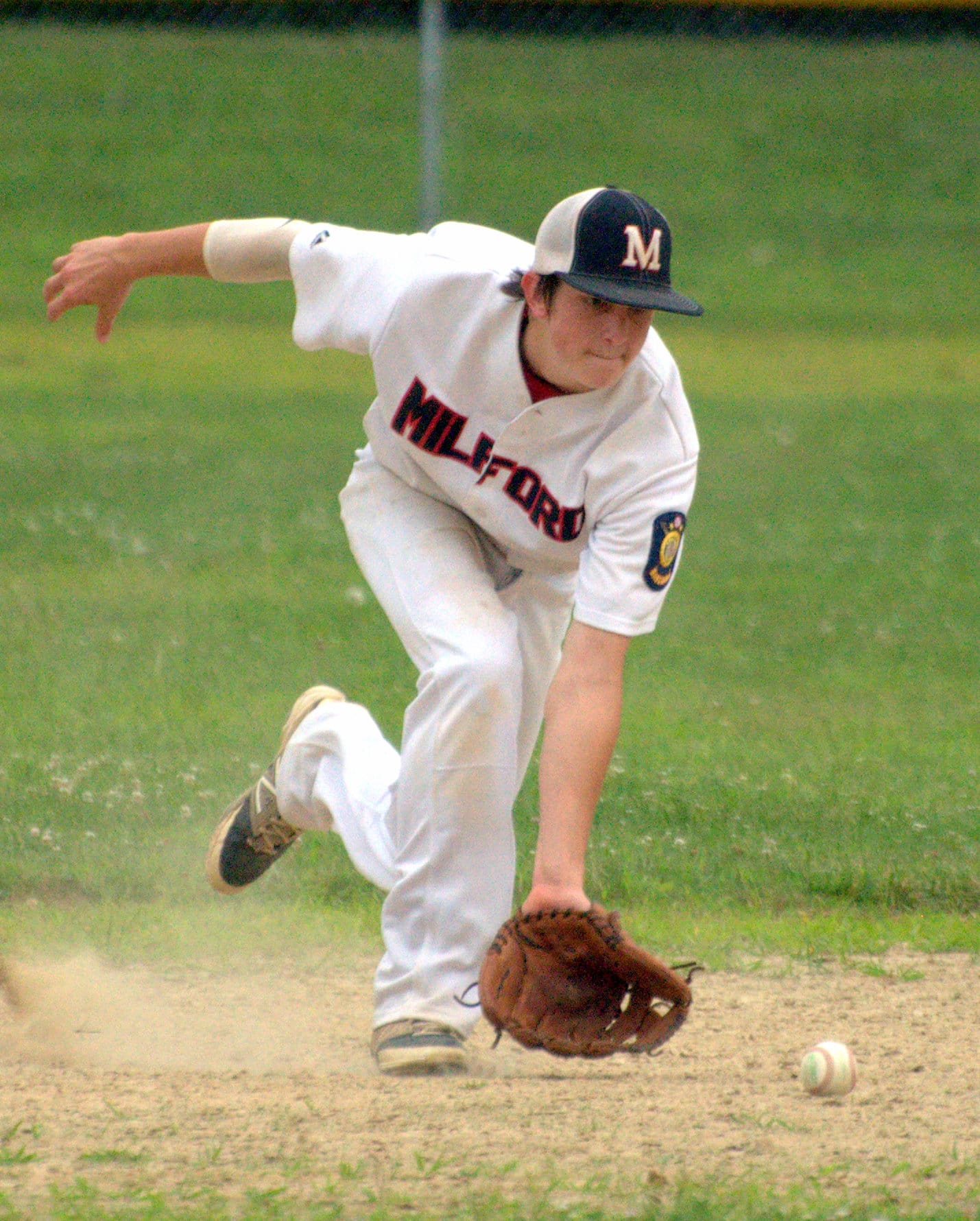 Milford's Tommy Bennett tries to scoop up a groundball.