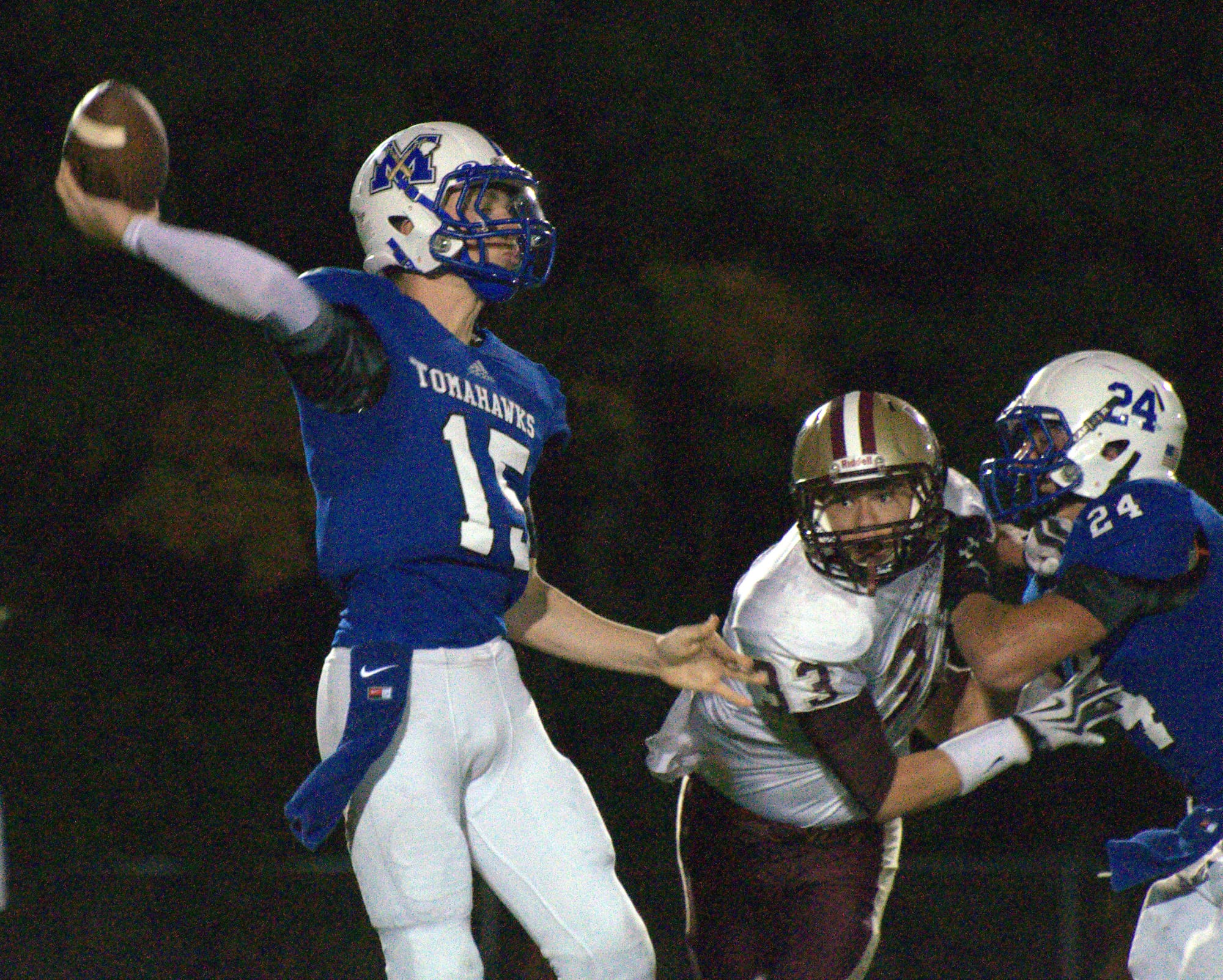 Merrimack's Justin Grassini gets rid of the ball as teammate Joe Giampietro tries to block Alvirne's Harold Leete.