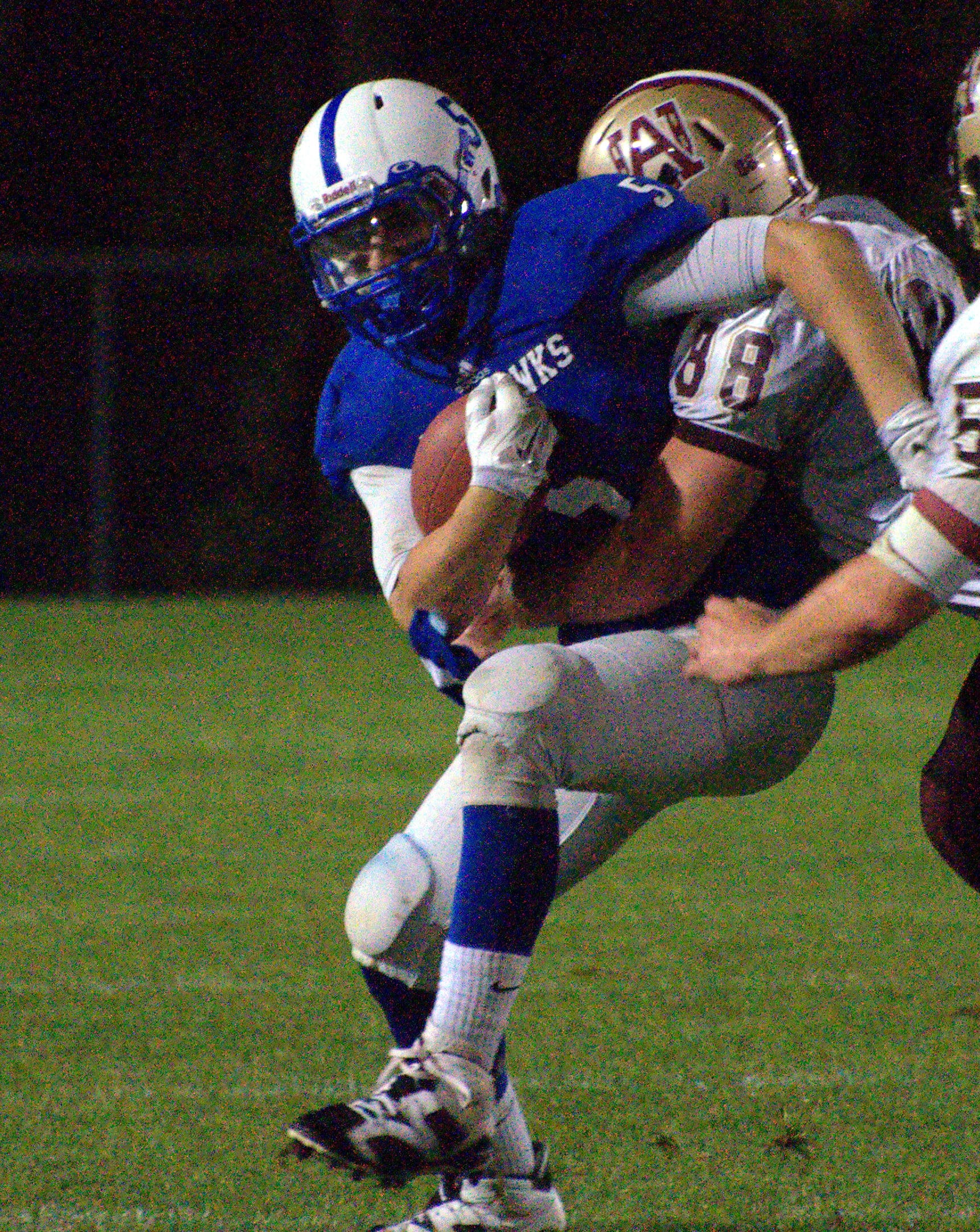 Alvirne's Tyler Janko tries to bring down Merrimack's Tyler DeNeill.