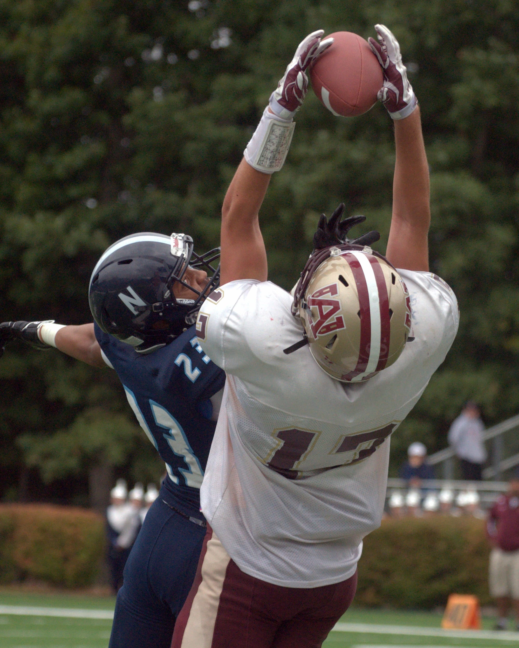 Alvirne's Andrew Stevens hauls in a pass as Nashua North's Ezinma Nwankwo defends during Saturday's game.