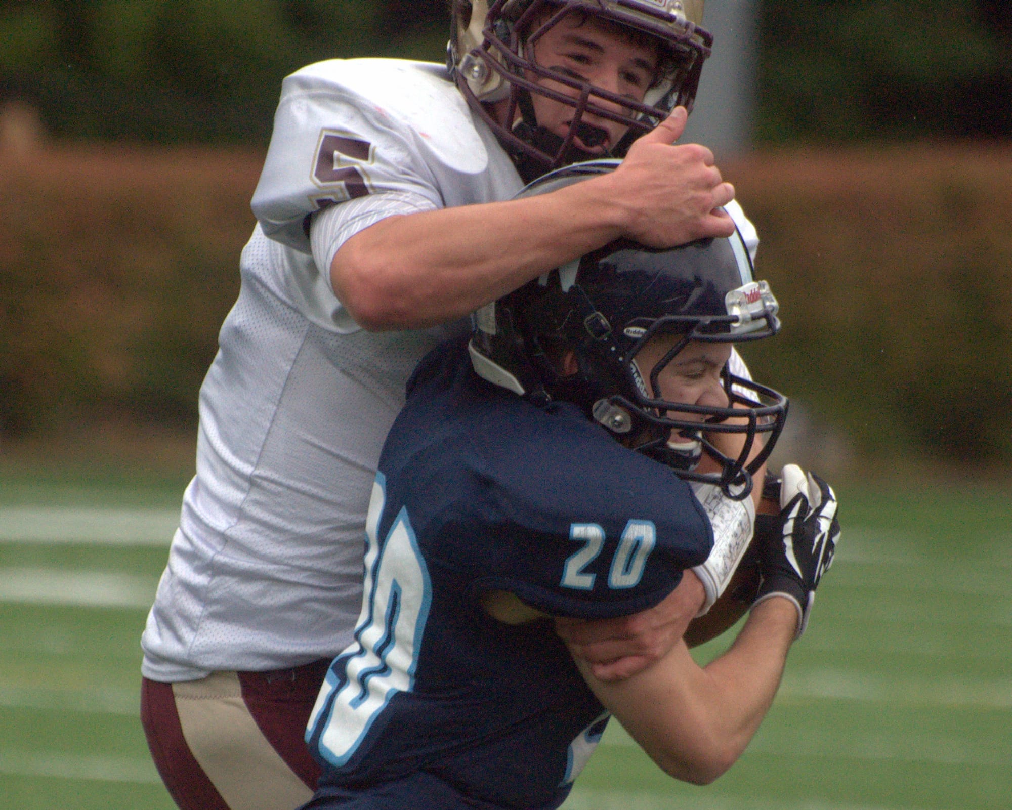 Alvirne's Jack Mahoney wraps up Nashua North's Dana Salem.