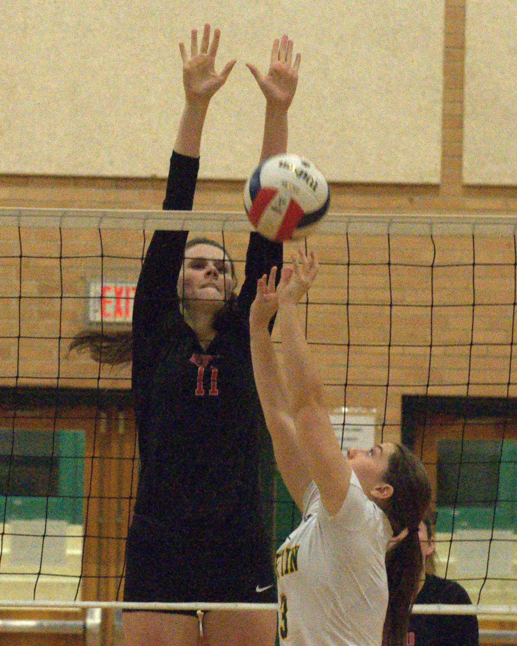Bedford's Rachel Larrivee tries to block a shot by Bishop Guertin's Jenna McCormack during Tuesday's match.