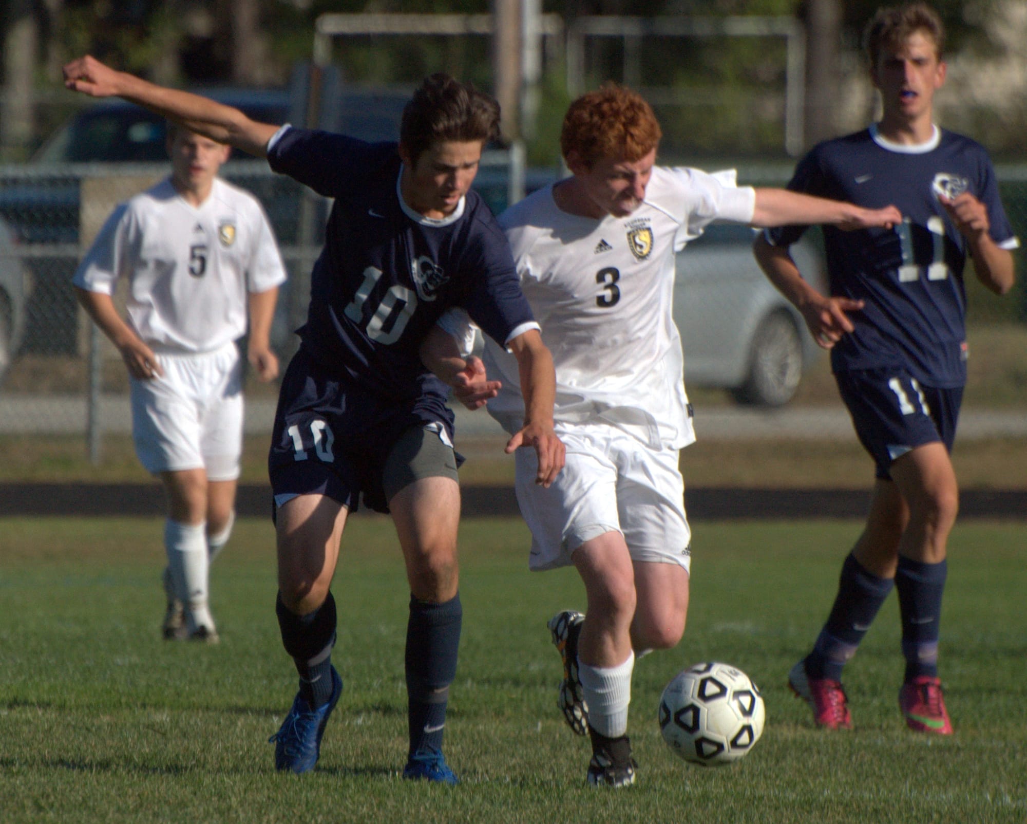 Hollis Brookline's Nate Rogers and Souhegan's Devan Casey battle for the ball during Friday's game.