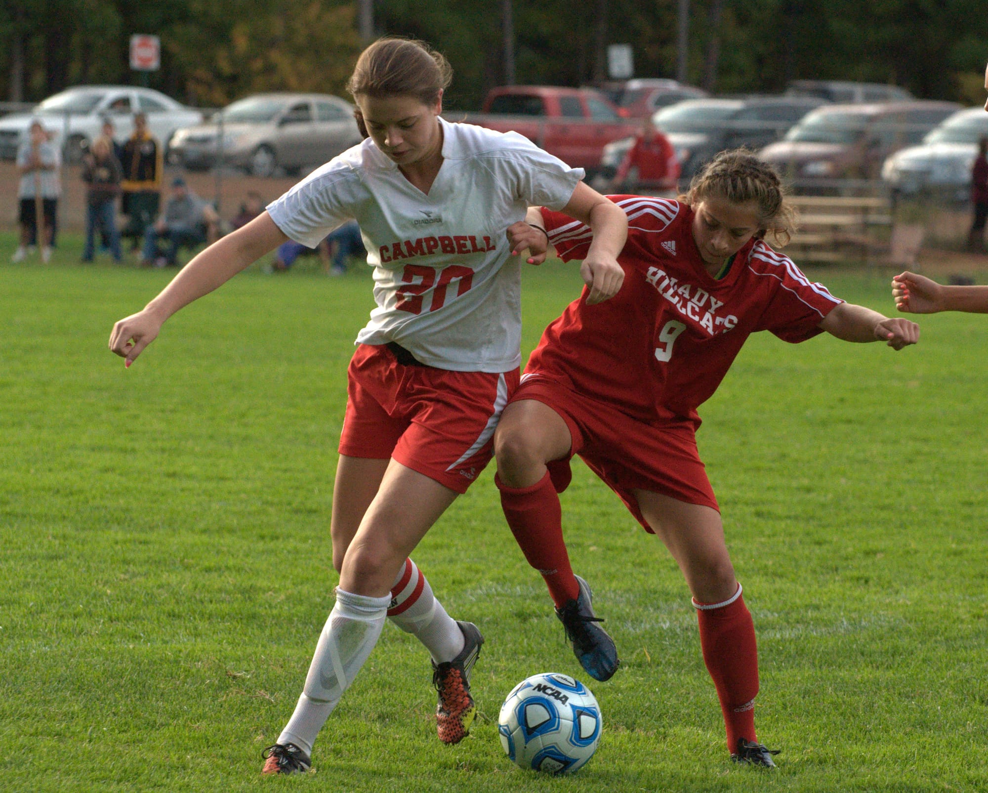 Campbell's Hanna Neild and Hillsboro-Deering's Paytne Walker battle for the ball.
