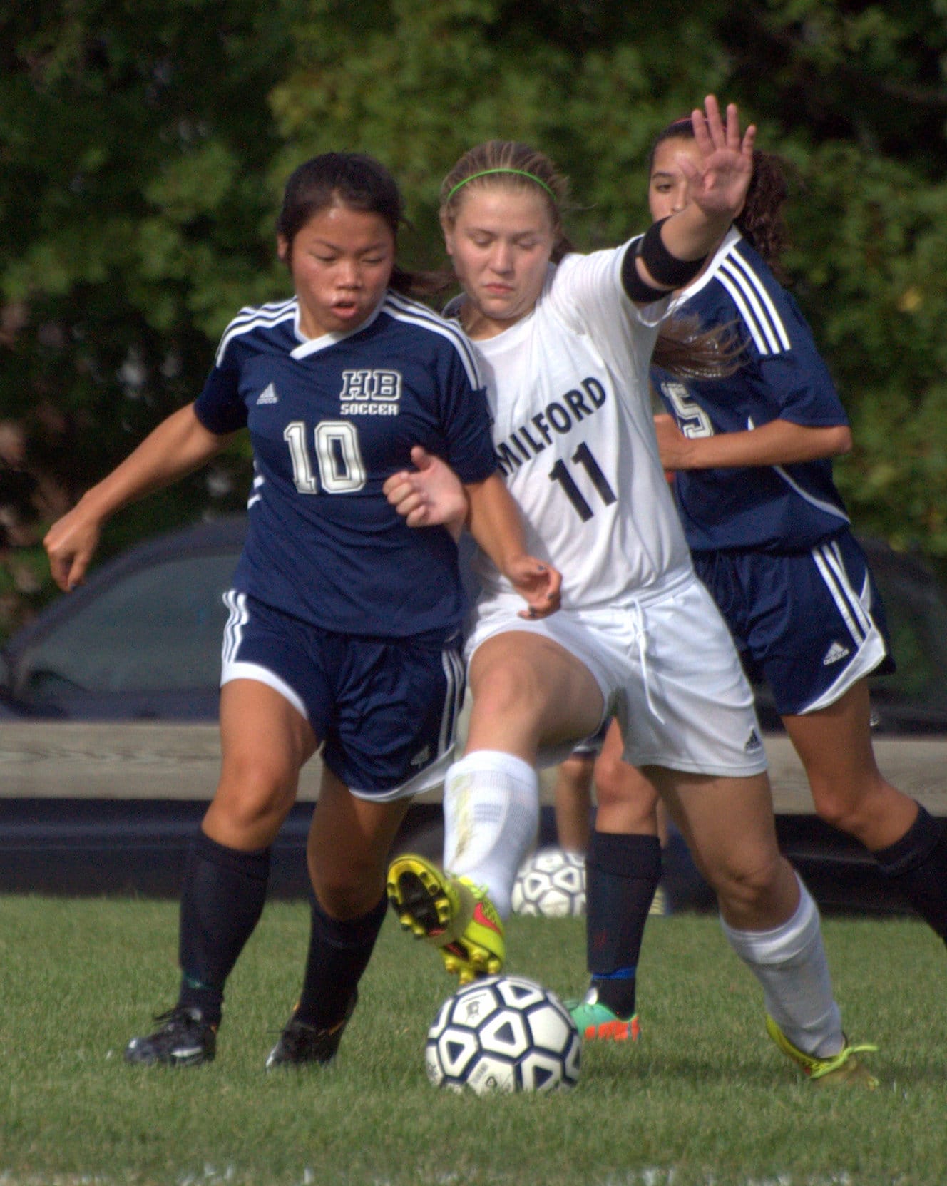 Hollis Brookline's Holly Eisenberg and Milford's Erin McGuire battle for the ball during Tuesday's game. For more photos, go to the Photo Album.