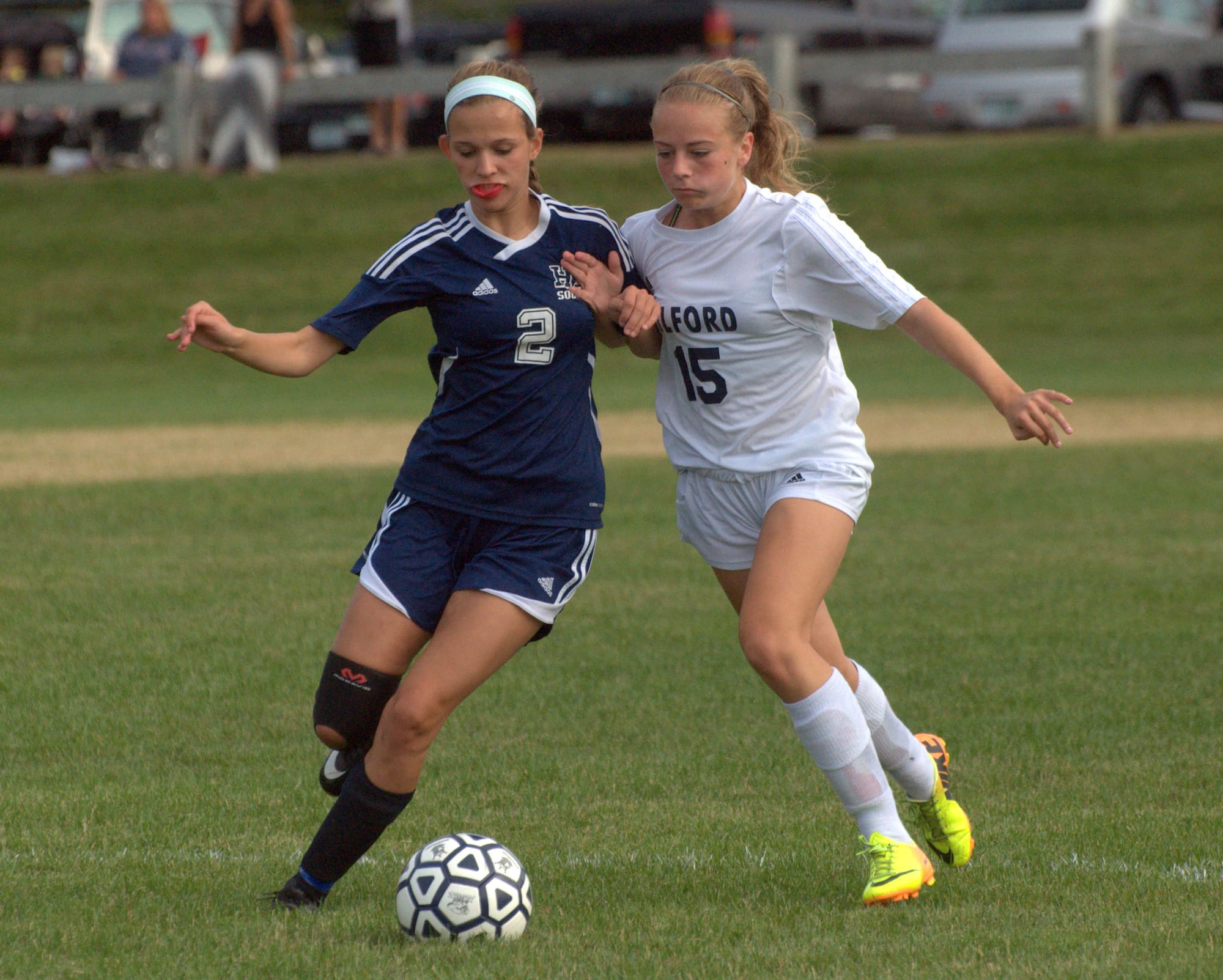 Hollis Brookline's Taylor Cook and Milford's Morgan Grill go after the ball.