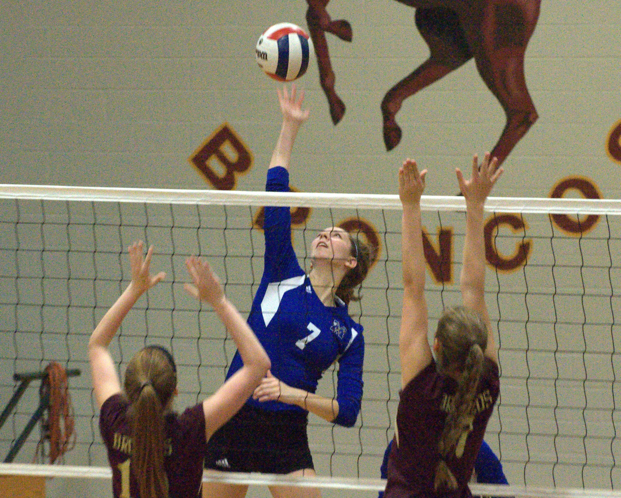 Merrimack's Elise Jolly hits the ball over two Alvirne players during Monday's match.