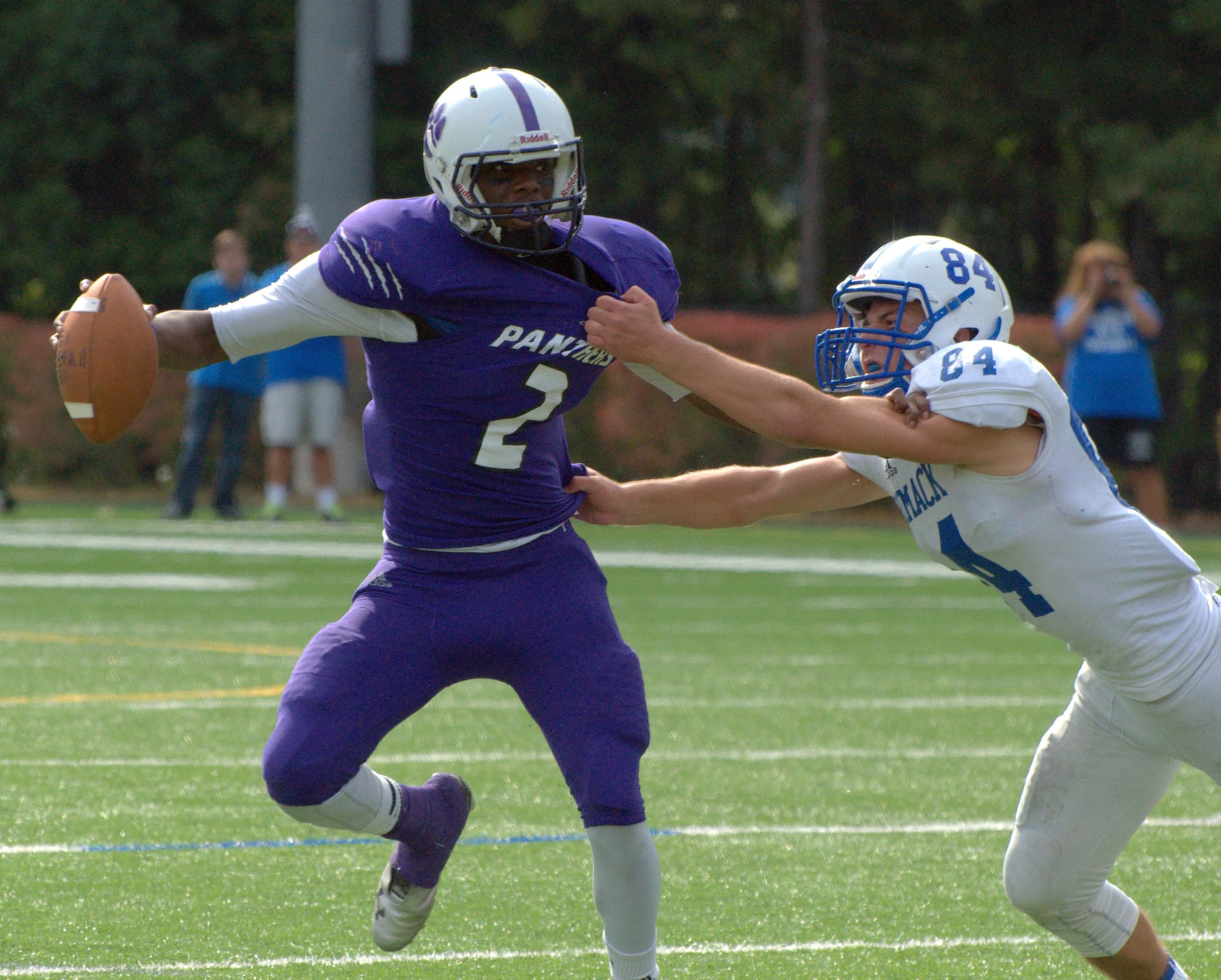 Nashua South's Malik Langa fights off a tackle by Merrimack's Daniel McKillop during Saturday's game.