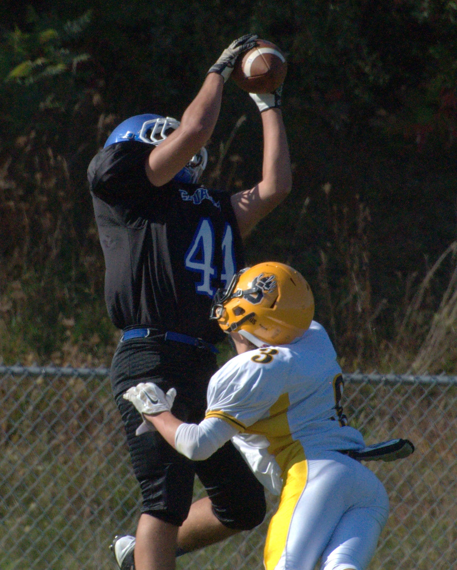 Hollis Brookline's Tommy Grant catches a touchdown over Souhegan's Brendan Cray.