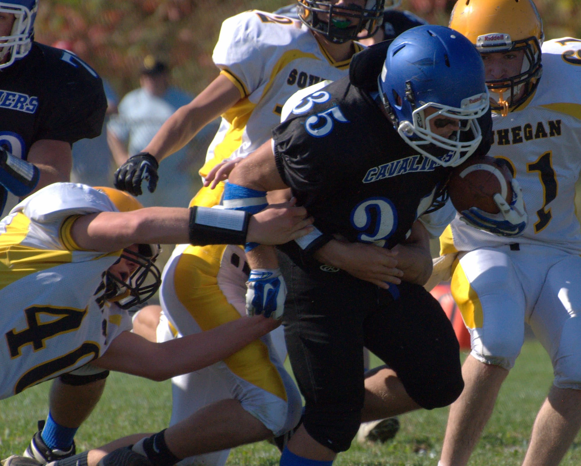 Souhegan's Cam Kinney tries to pull down Hollis Brookline's Wyatt Farwell.