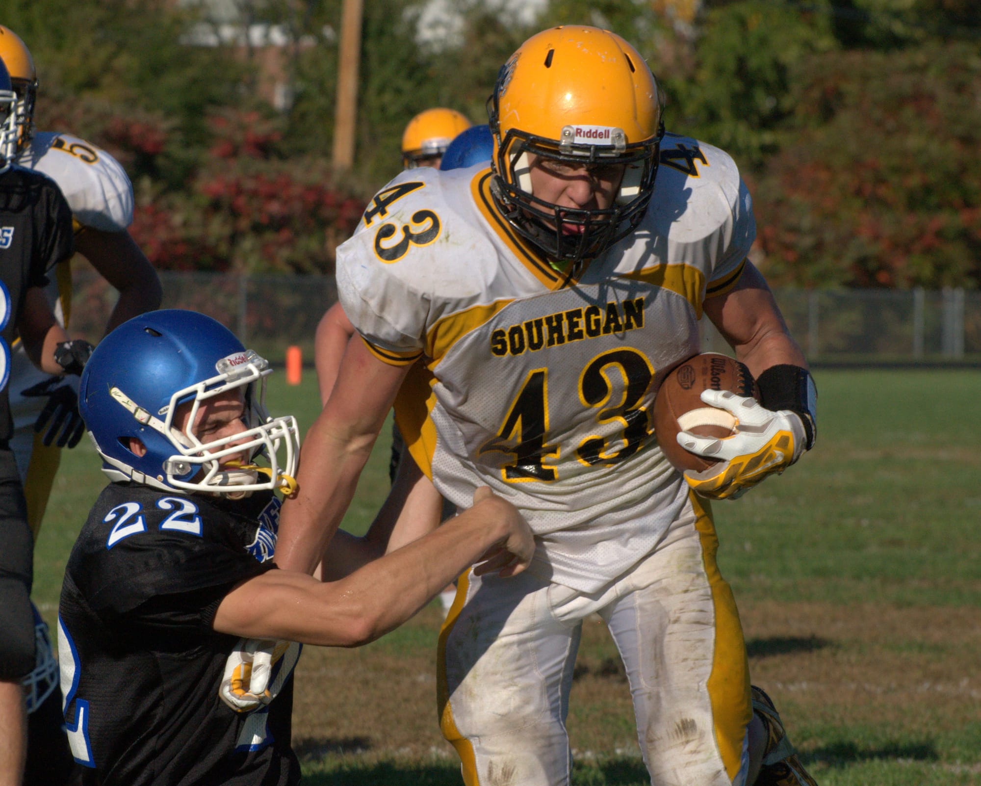 Souhegan's Tyler Howard breaks a tackle by Hollis Brookline's Patch Zorn on his way to the end zone during Saturday's game. 