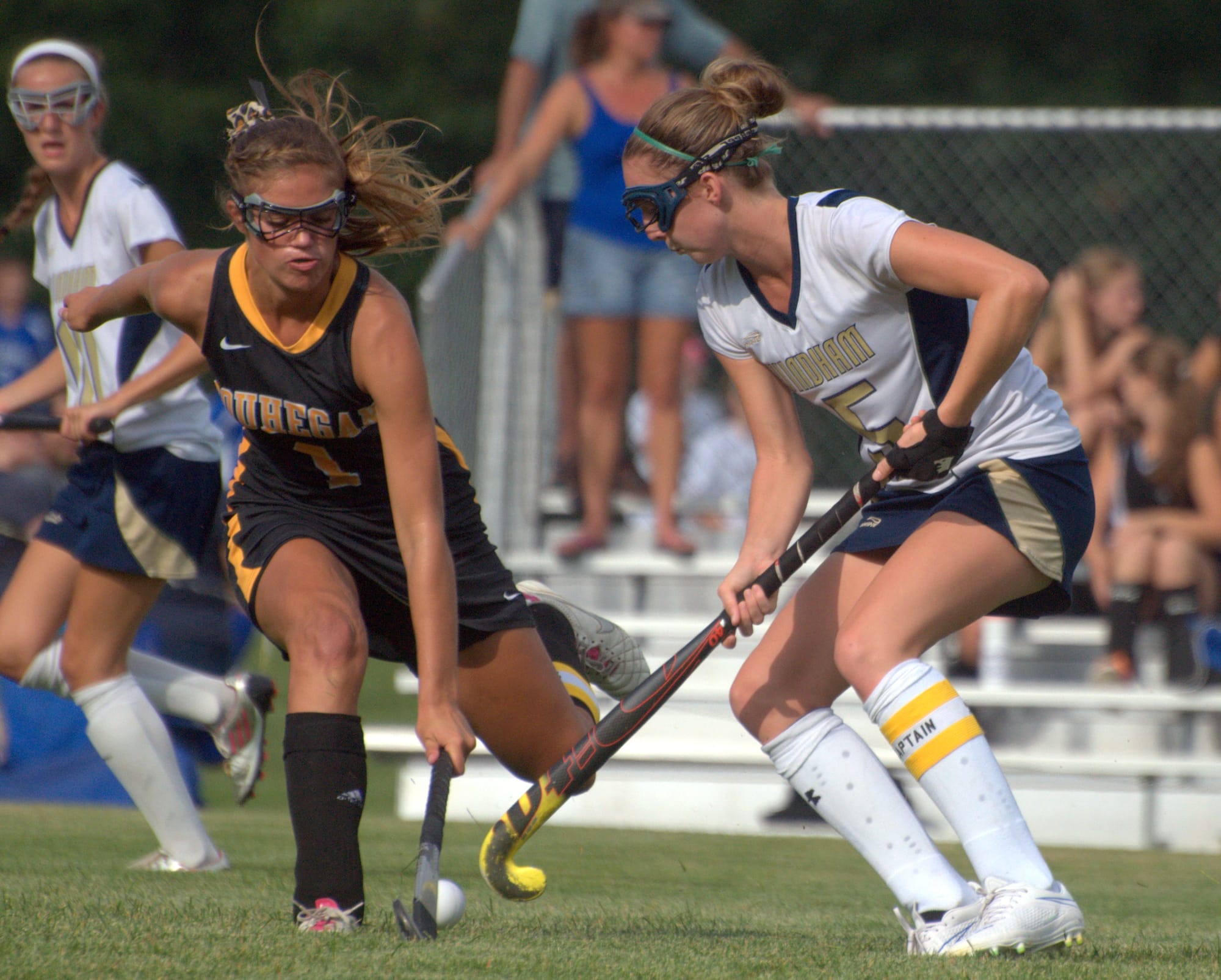 Souhegan's Lauren McCormick tries to knock the ball away from Windham's Courtney Sweeney.