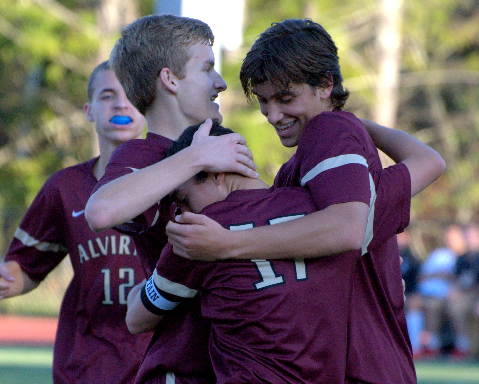 Alvirne's Matt Lubinski, center, is congratulated after his first goal by teammates Nate Gosselin, left, and Raul Stedile during Friday's game at Bedford.