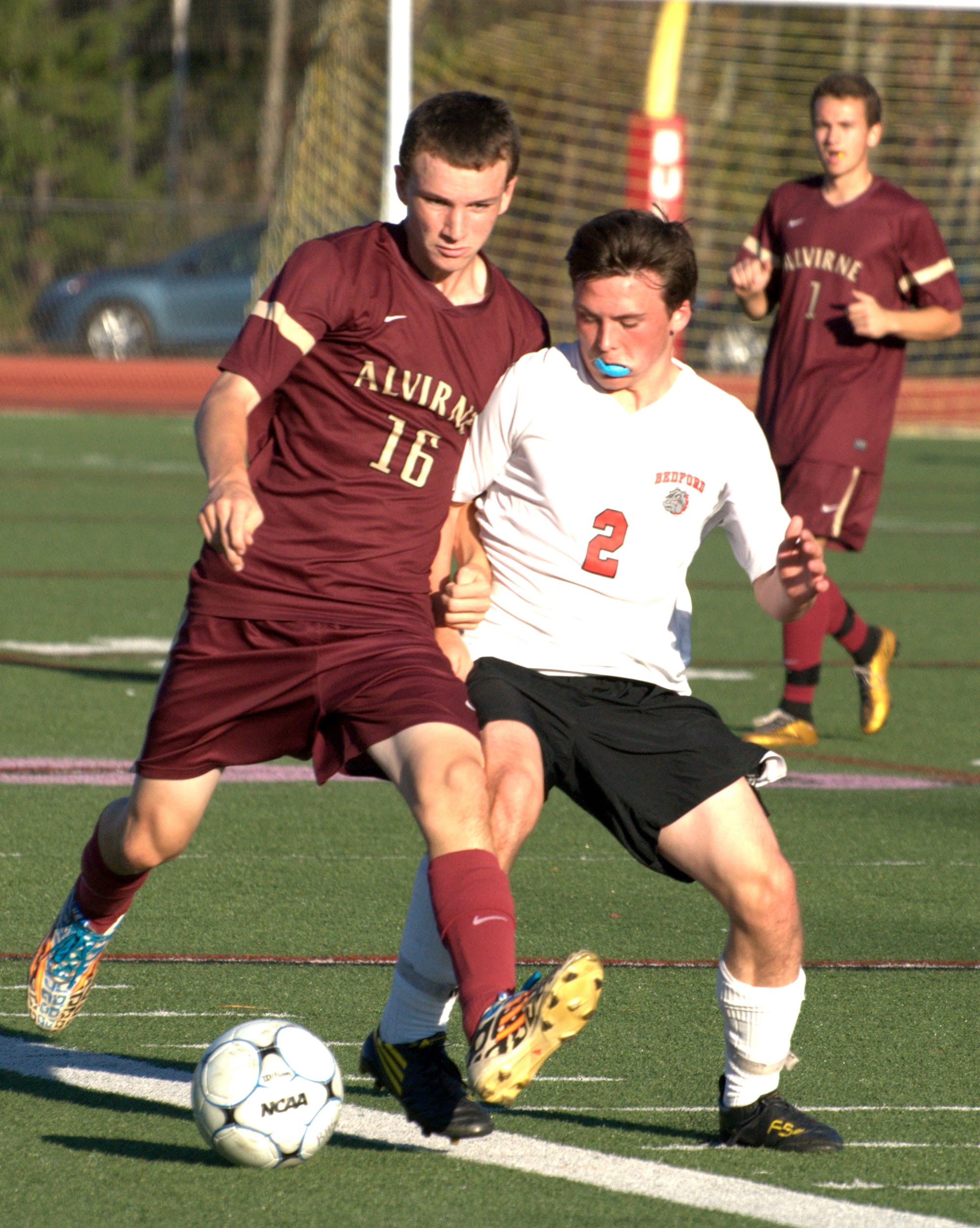 Alvirne's Anthony Holzhauser and Bedford's Benjamin Dow battle for the ball.
