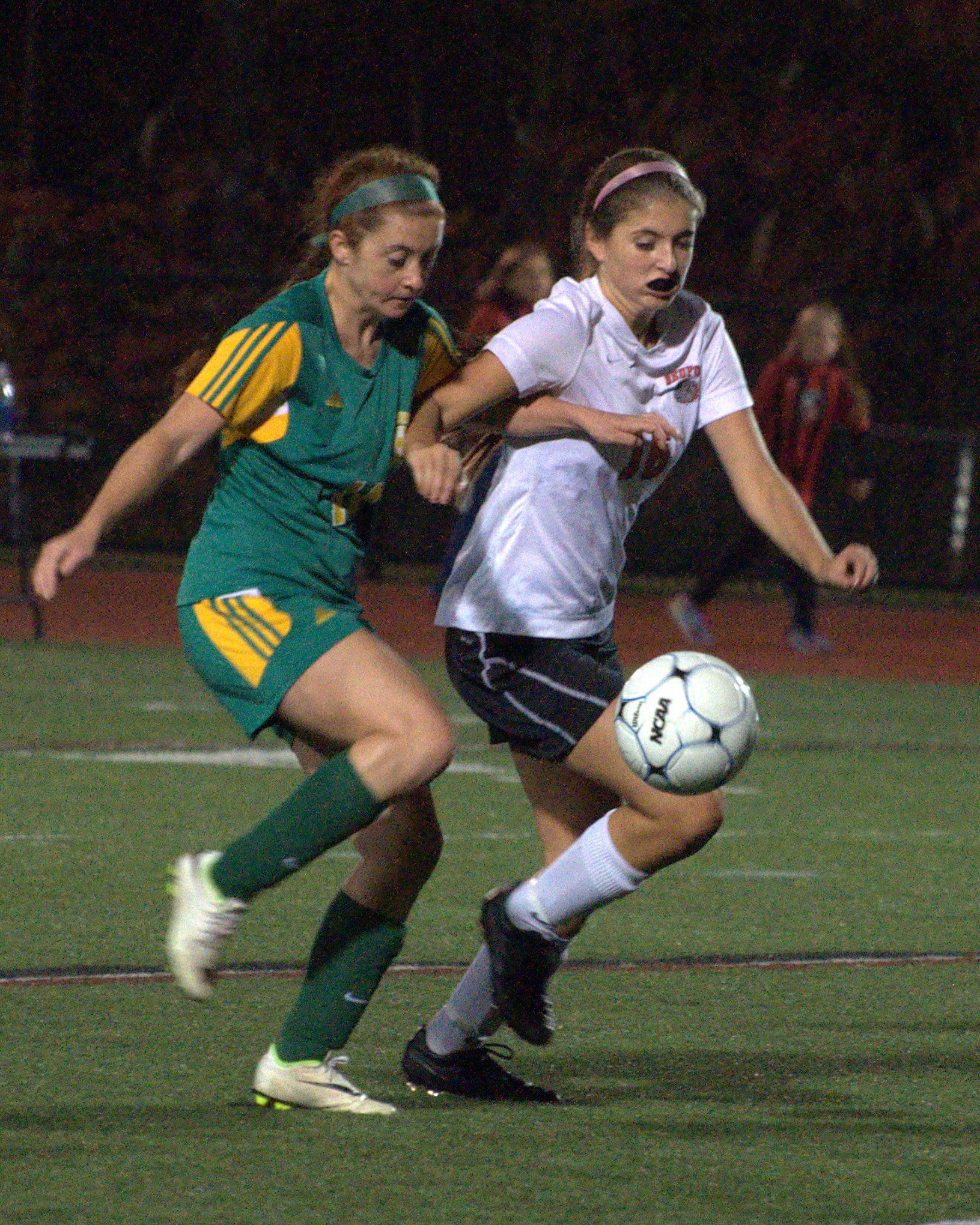 Bishop Guertin's Mikayla Elliot and Bedford's Kate Shooshan go after the ball.