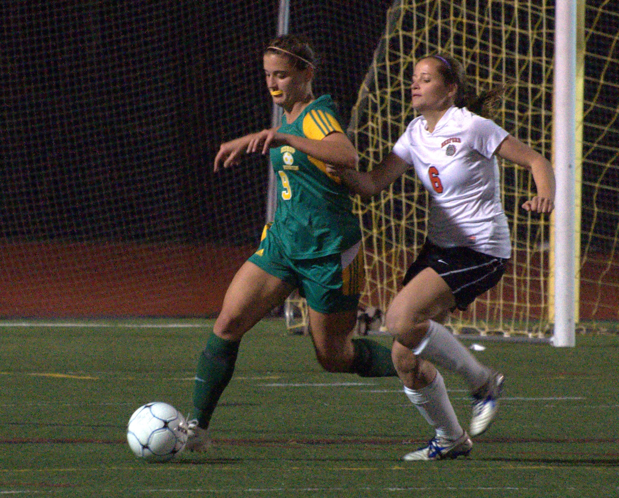 Bishop Guertin's Juliana Wooldridge tries to keep the ball away from Bedford's Sierra Soghikian during Tuesday's game.