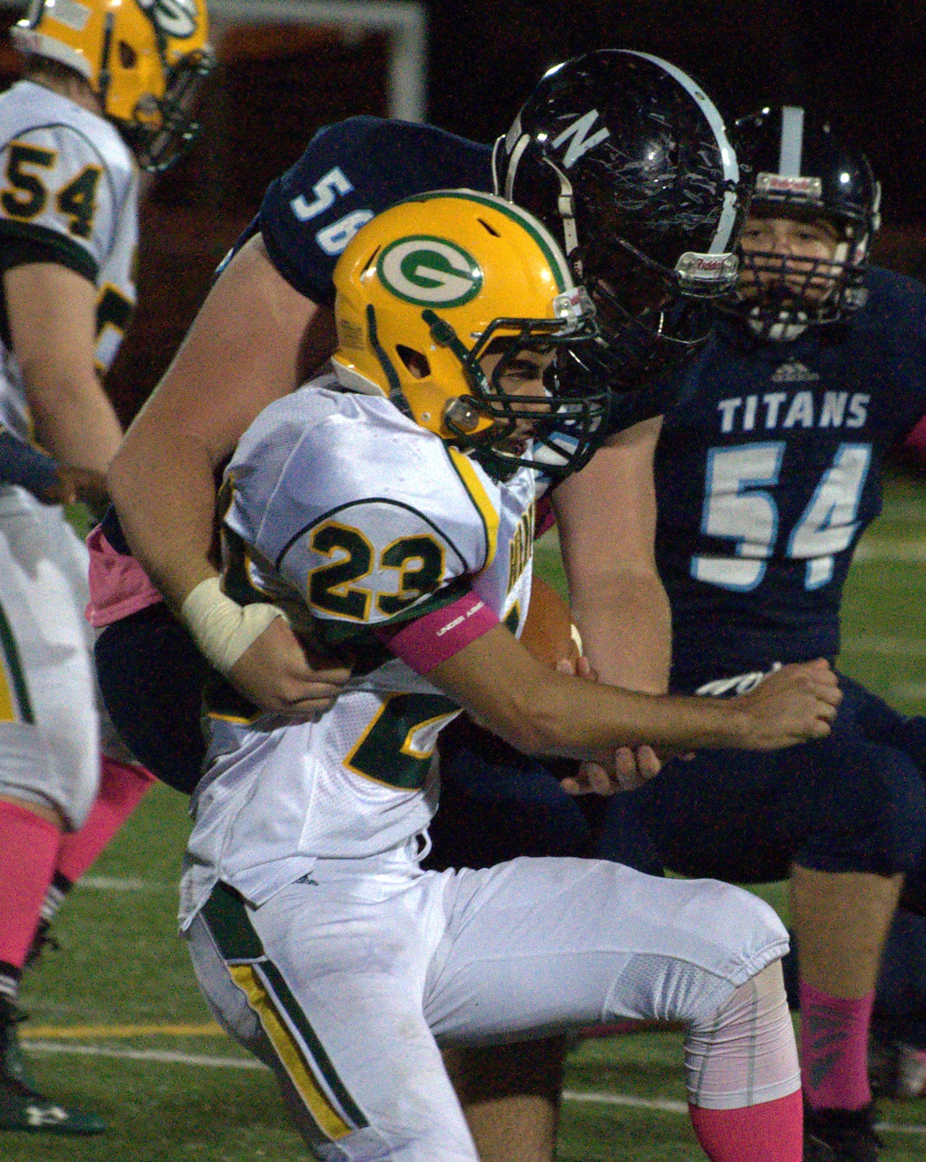 Nashua North's Matt Lavallee tries to bring down Bishop Guertin's Kelvin Rivera.