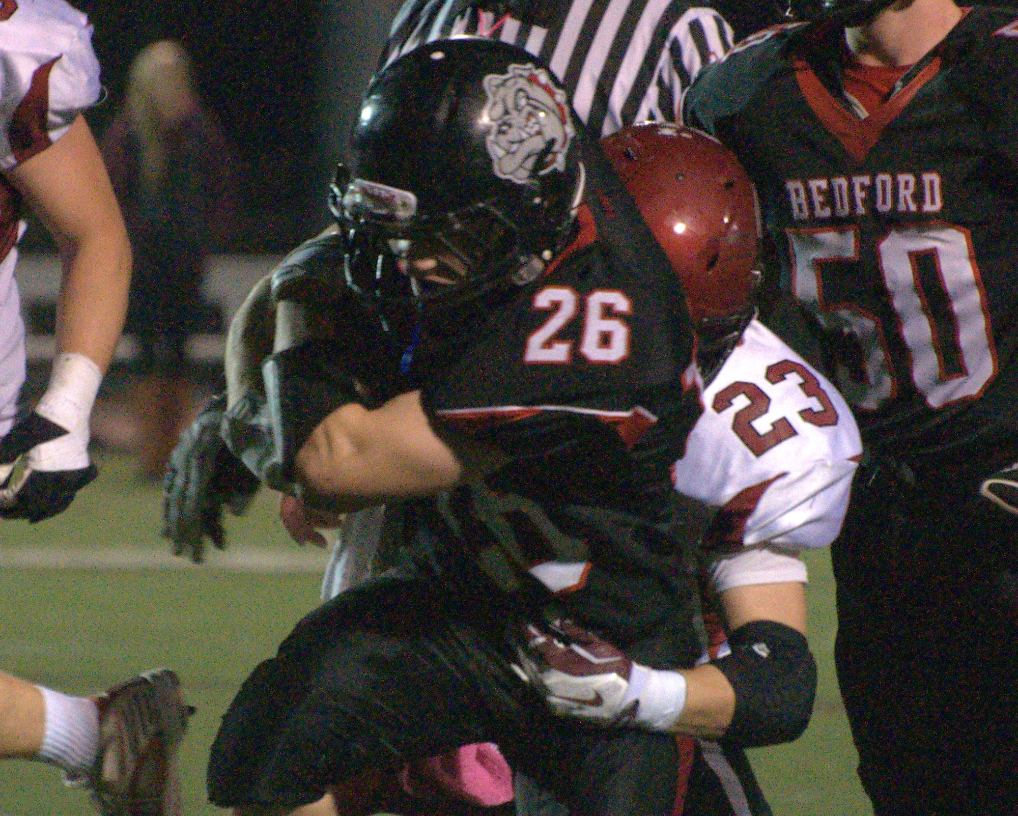 Bedford's Colin Cashin tries to break a tackle by Concord's Connor Kukla during Friday's game.