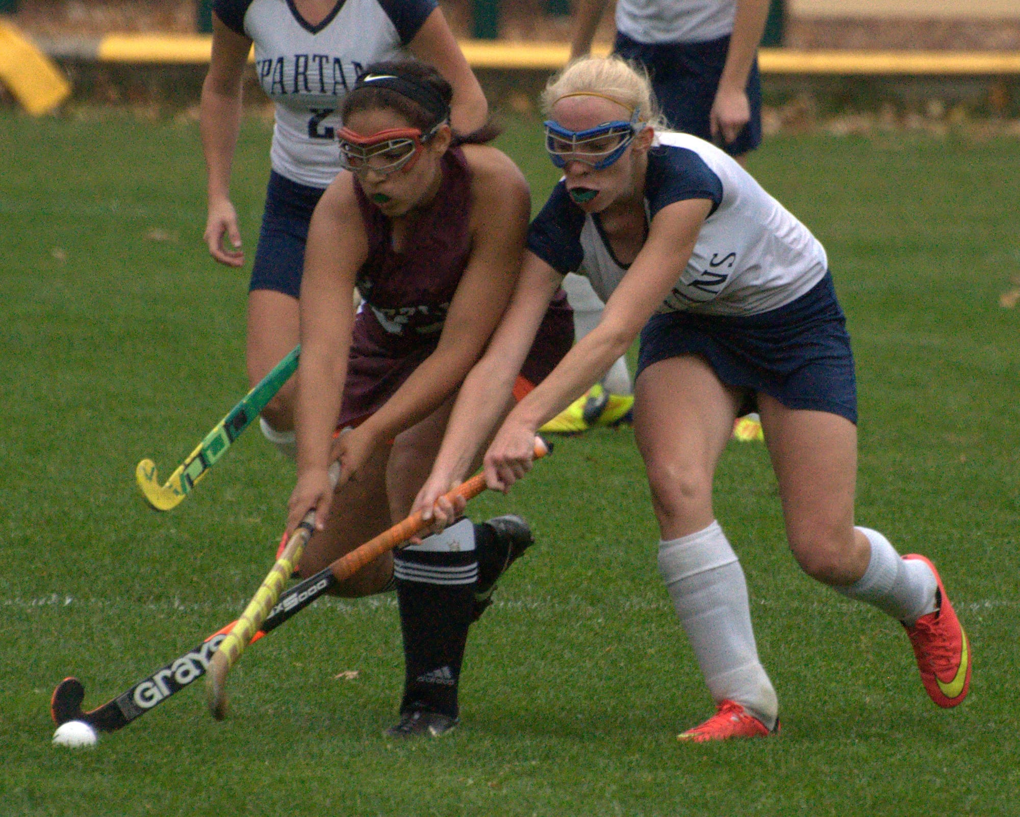 Goffstown's Shaugnessy Benoit and Milford Kelsey Poulter go after the ball during Tuesday's Division II preliminary round game.