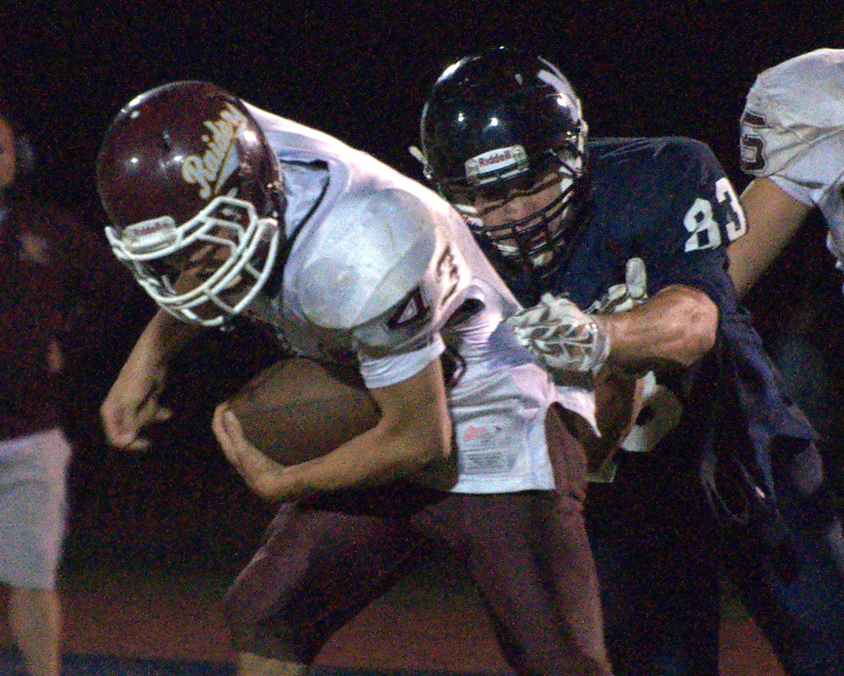 Lebanon's Joseph Flanagan tries to get away from Milford's Nick Skinner.