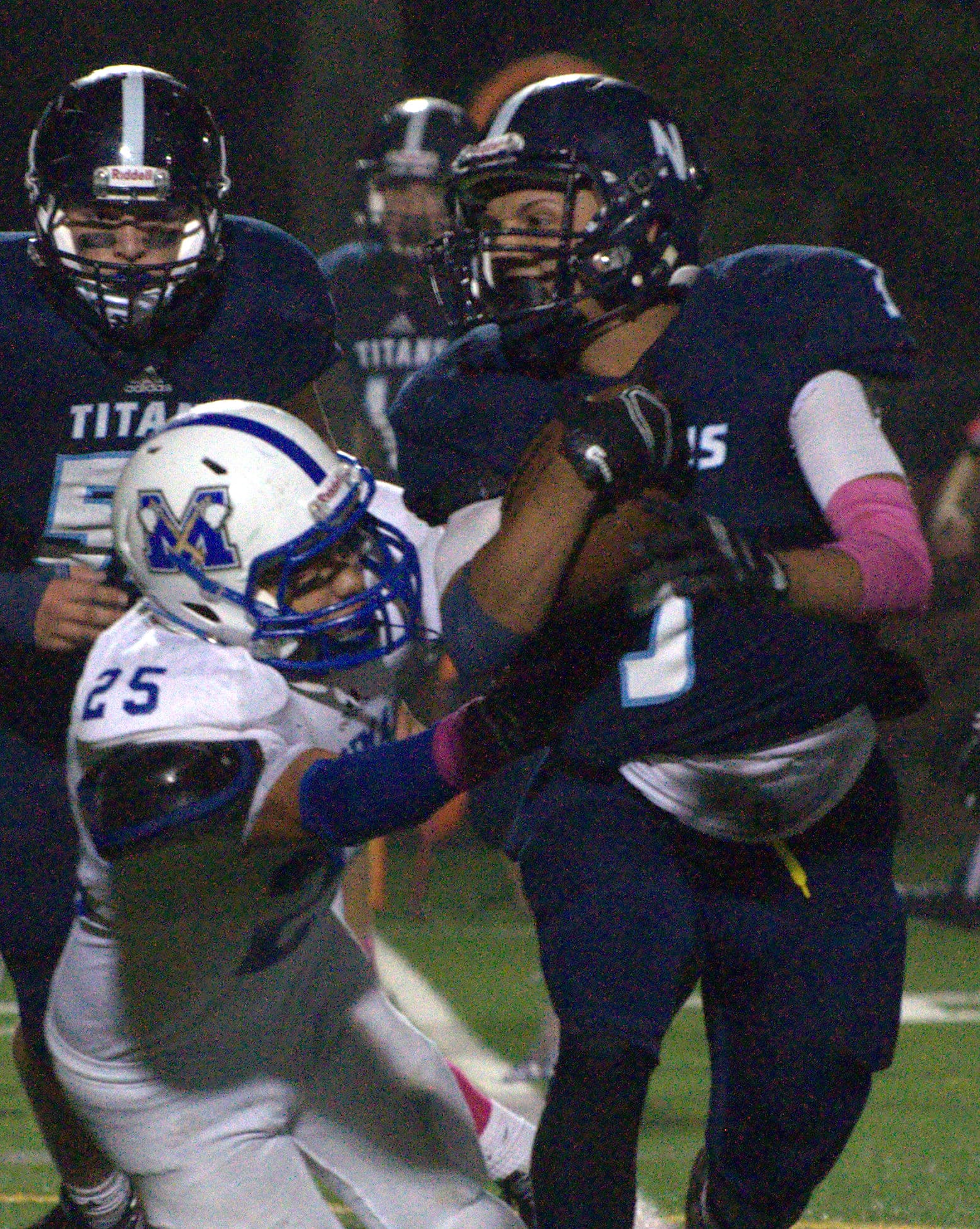 Nashua North's Myles Cassin-Reed escapes a tackle by Merrimack's Andrew Dichard.
