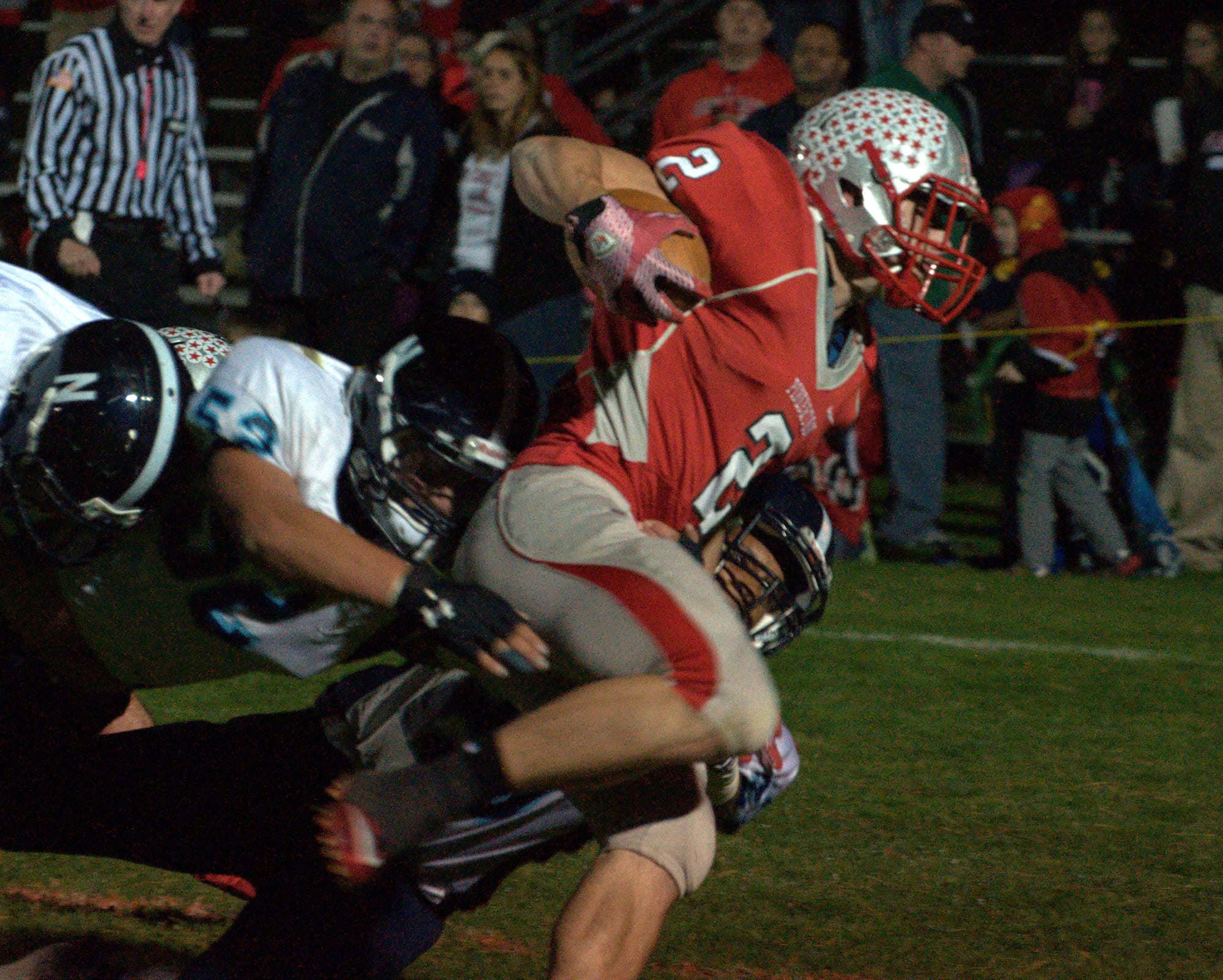Pinkerton's Peter Cyr powers past three Nashua North defenders for one of his three touchdowns Friday night.
