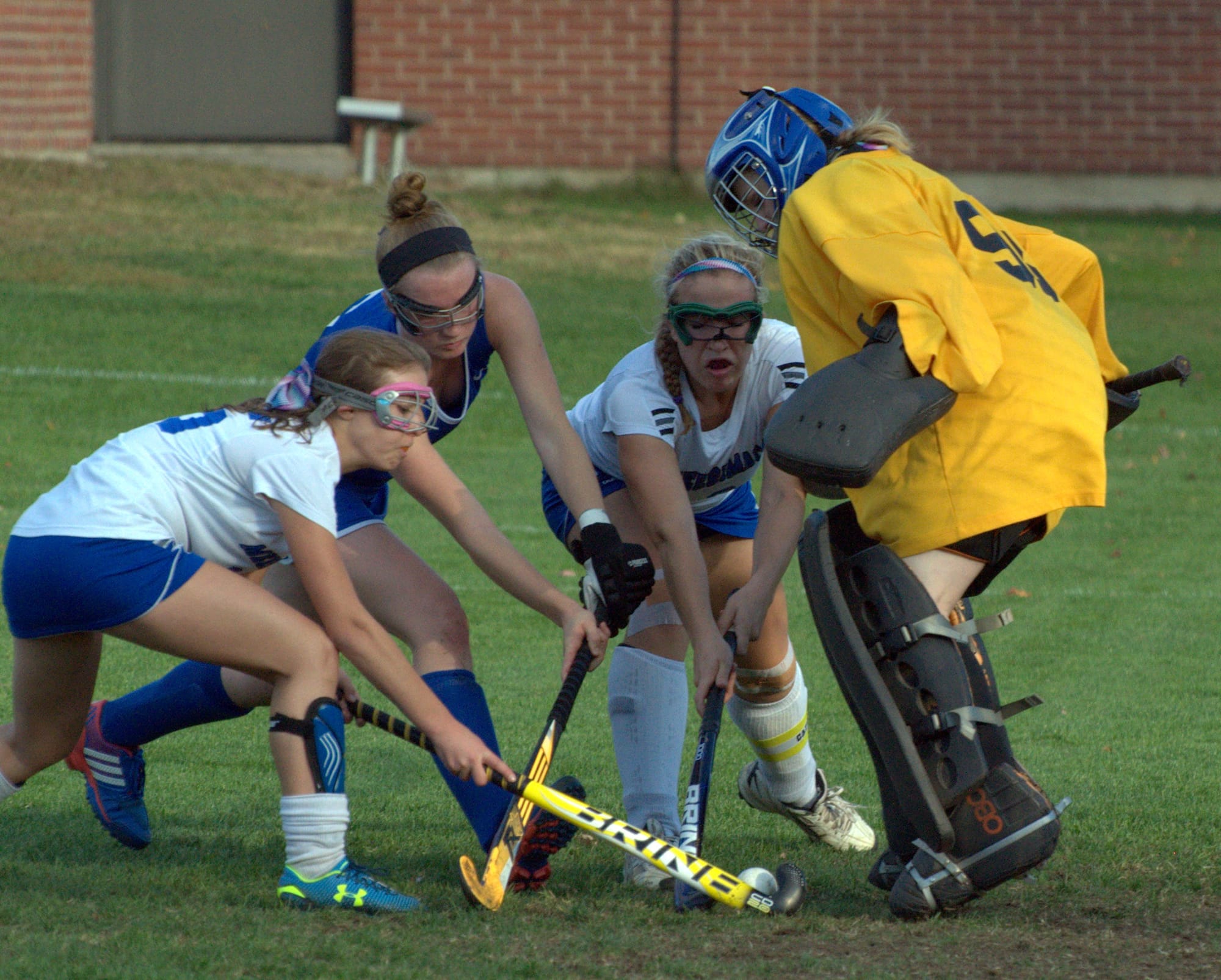 Winnacunnet and Merrimack players fight for the ball in front of Merrimack goalie Mac Hennas during Wednesday's game.