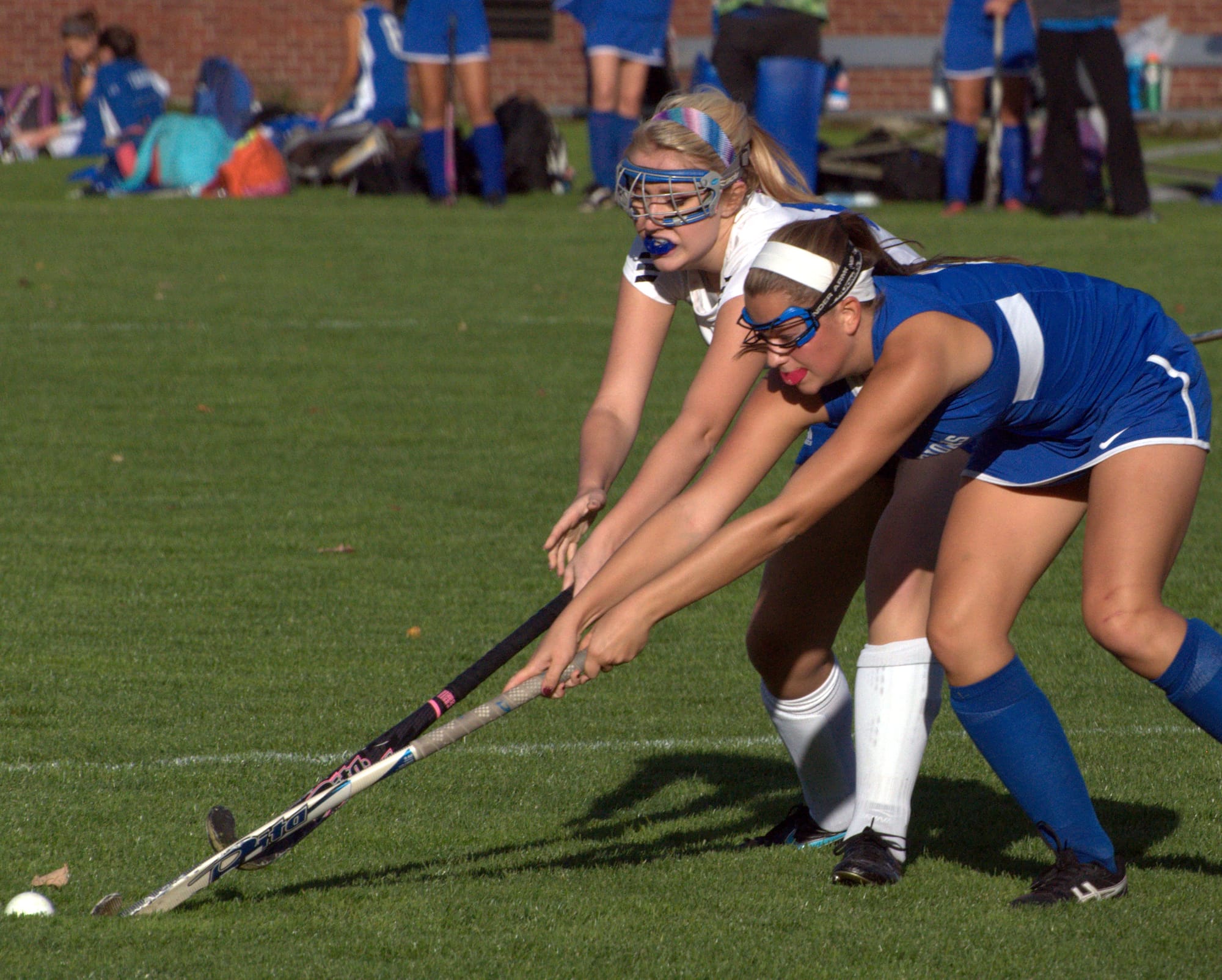 Winnacunnet's Britini Ballance and Merrimack's Jordan Fleckenstein try to get the ball.