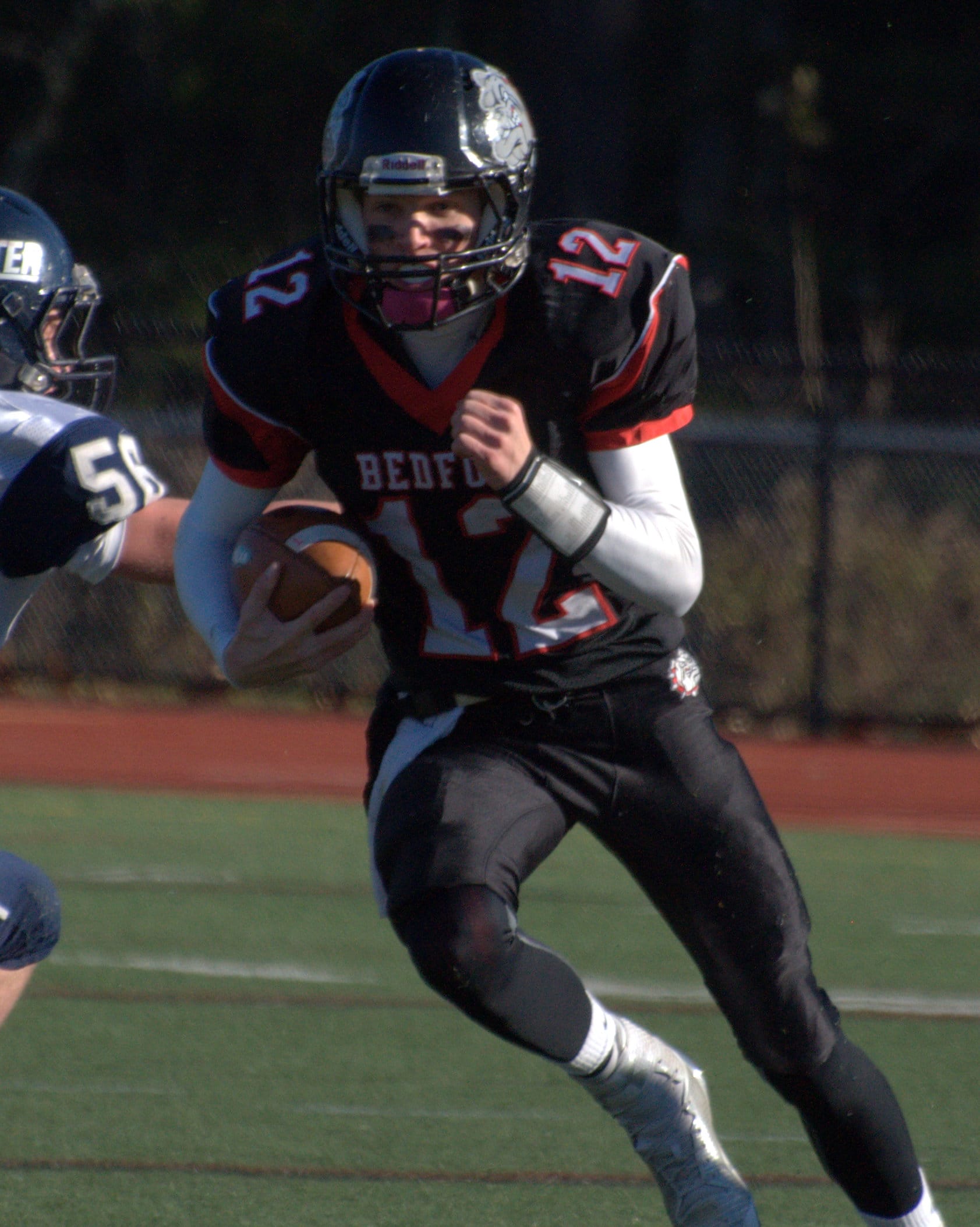 Bedford's Tyler Cibotti runs with the ball during the first half.