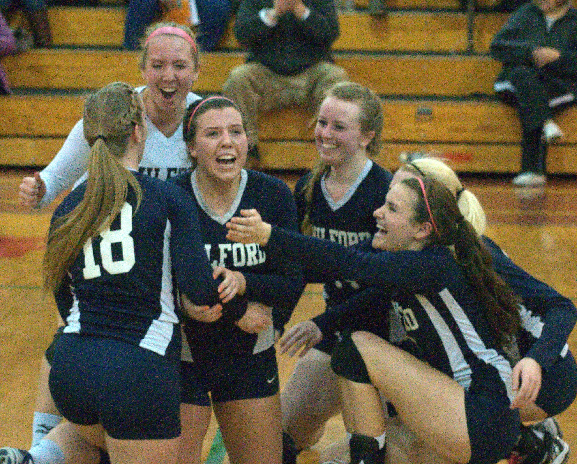 The Milford girls volleyball team celebrates after its win over Gilford in the Division II semifinals.