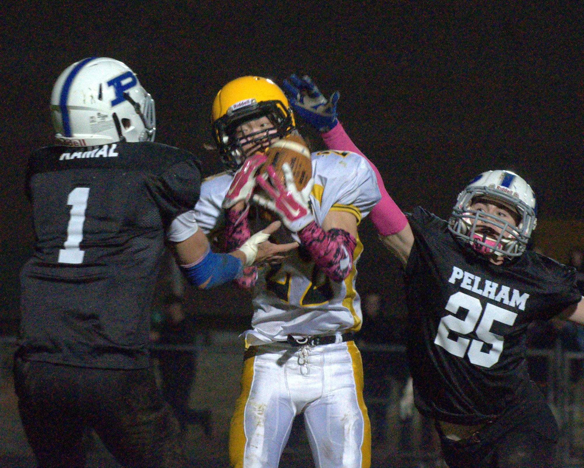 Souhegan's Zach Bossi hauls in a pass during Friday's game against Pelham.